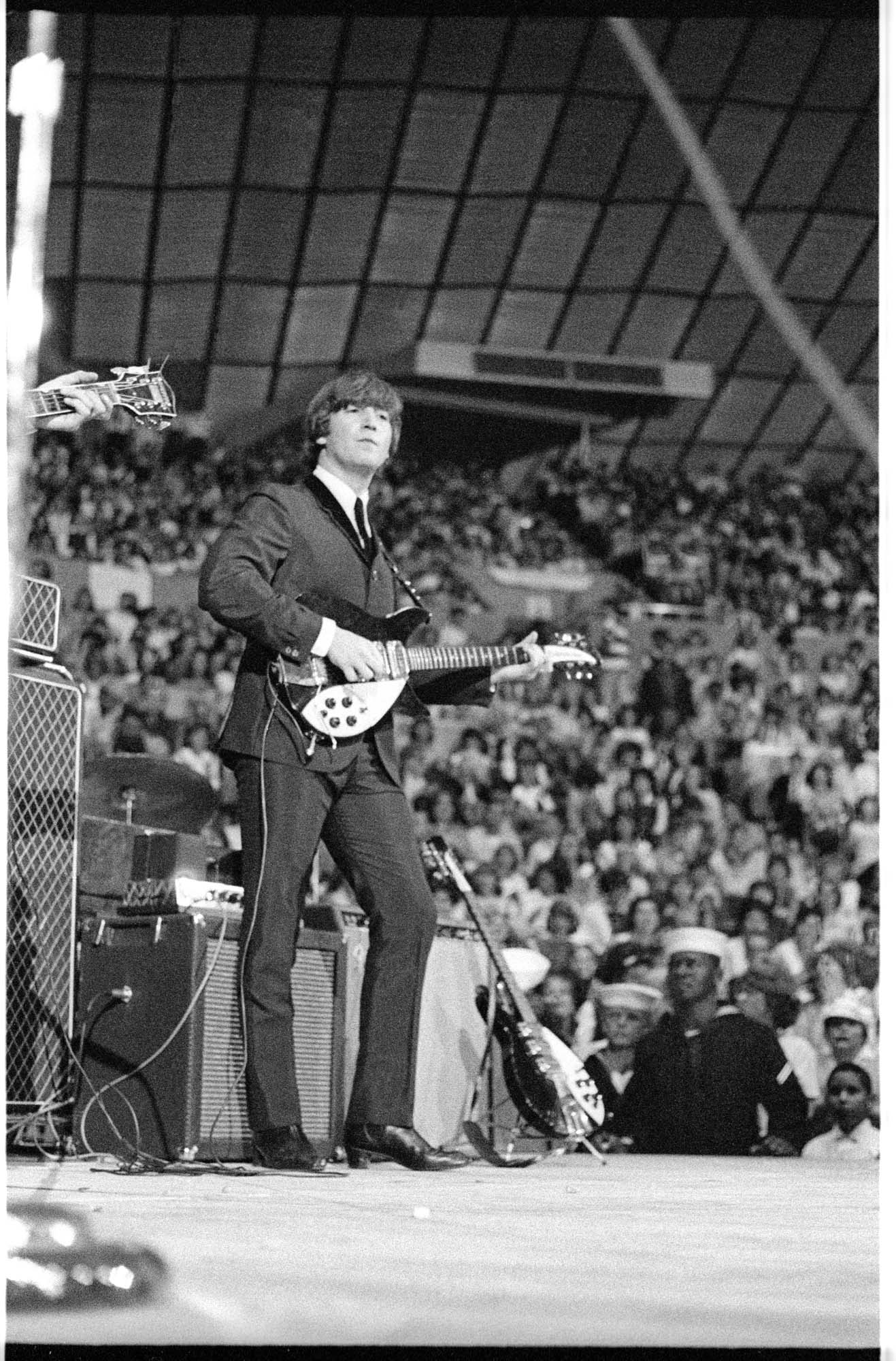 Image of John Lennon performing during the Beatles concert at Seattle Center Coliseum, August 21, 1964