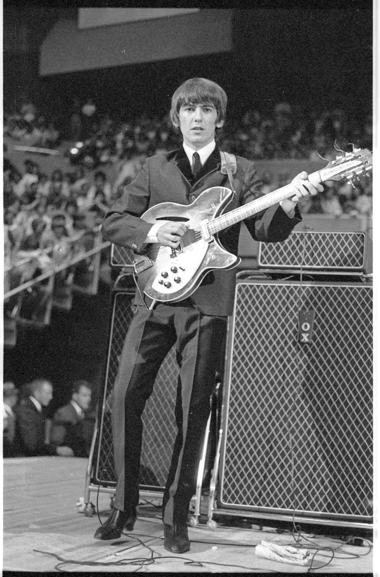 Image of George Harrison performing at the Beatles concert, Seattle Center Coliseum, August 21, 1964