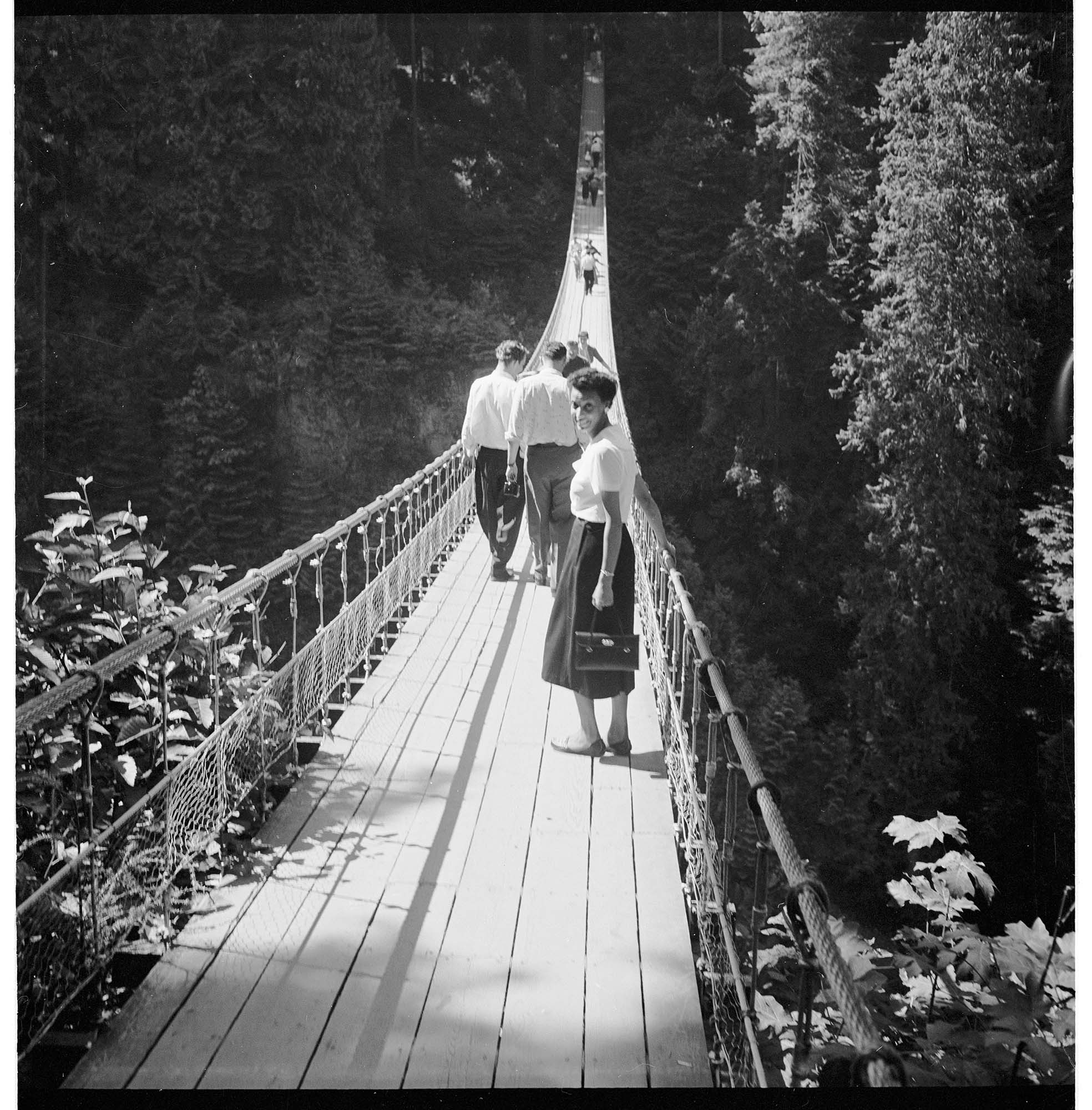 Image of Izzy Smith on the Capilano Suspension Bridge, Vancouver, British Columbia, circa 1950