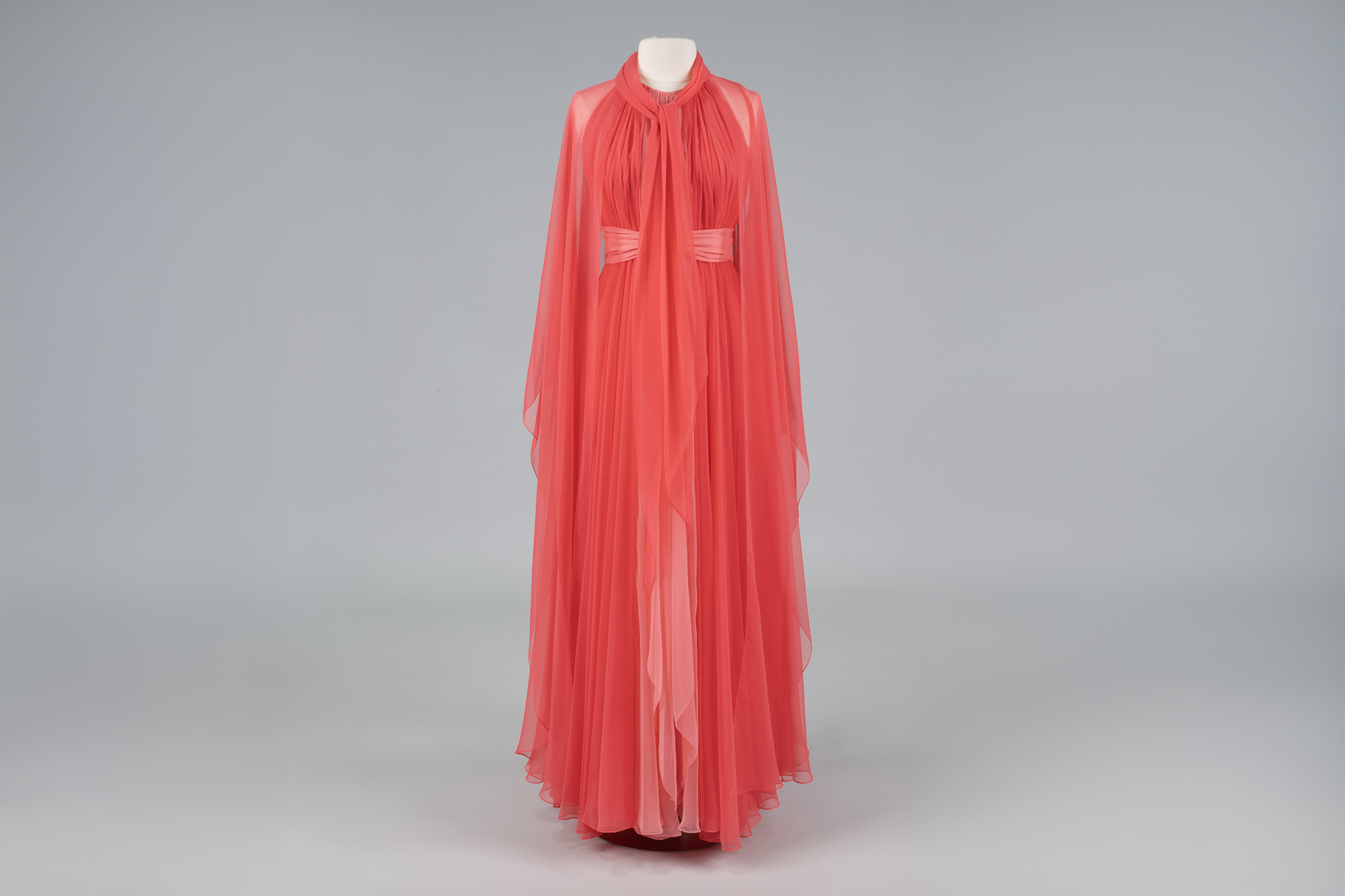 Image of Pink chiffon gown and cape designed by Kiki Hart, 1970s