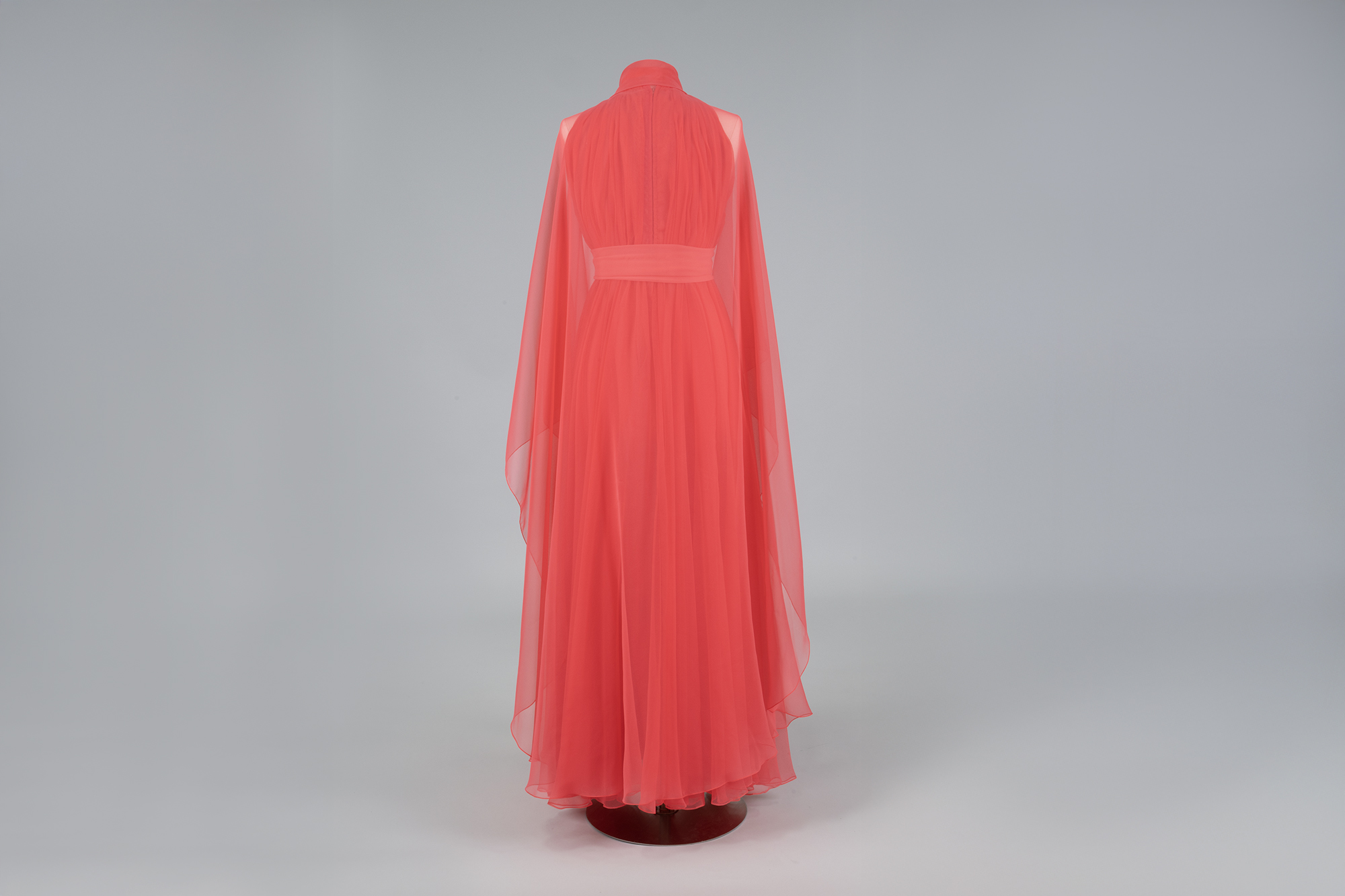 Image of Pink chiffon gown and cape designed by Kiki Hart, 1970s
