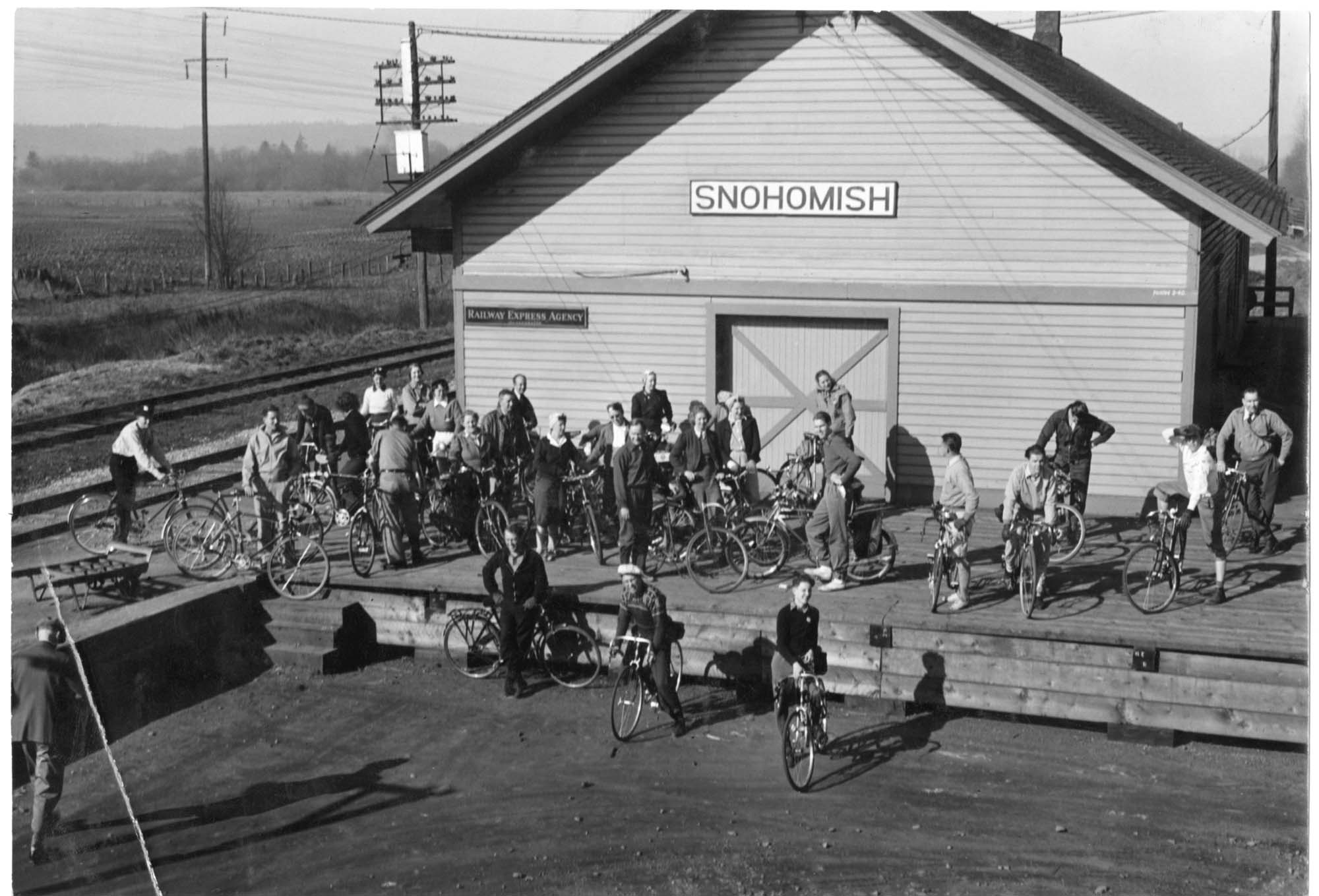 Image of Pacific Northwest Cycling Association group with bicycles at Snohomish train station, 1940