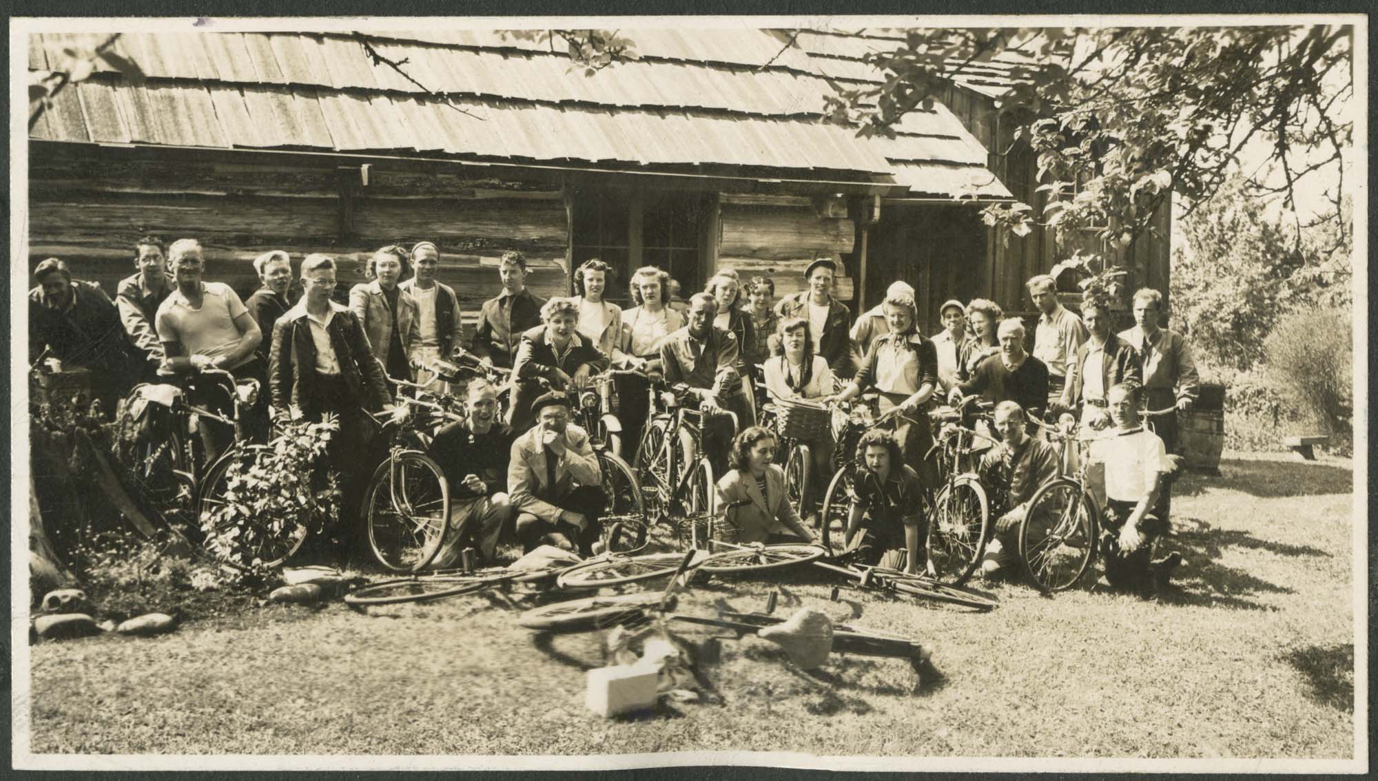 Image of Pacific Northwest Cycling Association group in front of cabin, circa 1950