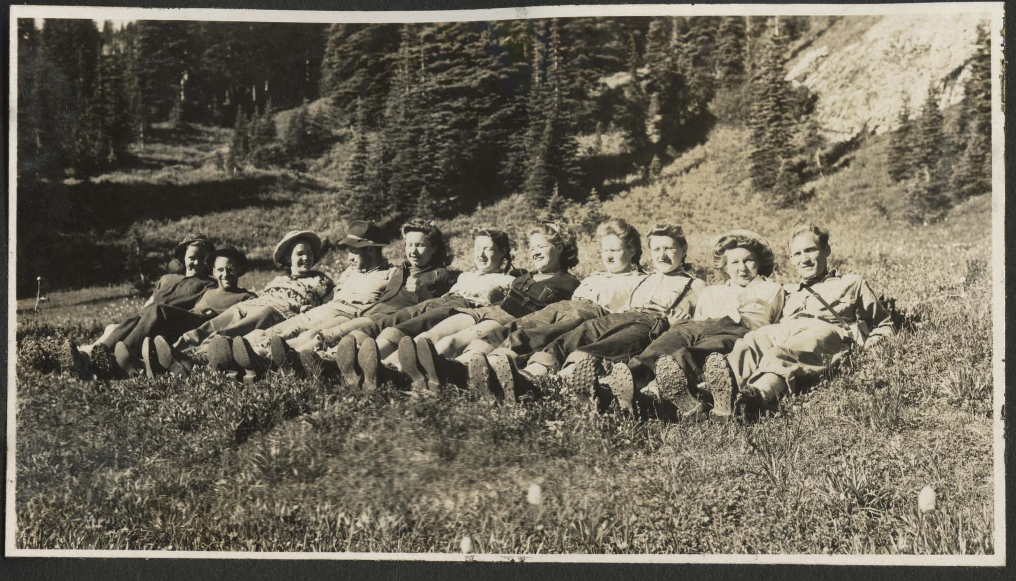 Image of Pacific Northwest Cycling Association members reclining on grass, circa 1950