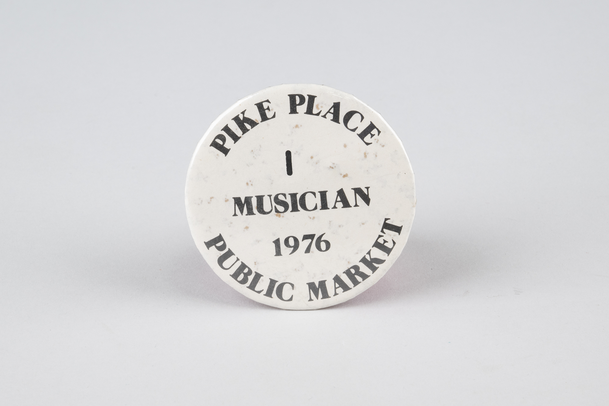 Image of First Pike Place Market busker's permit button, 1976