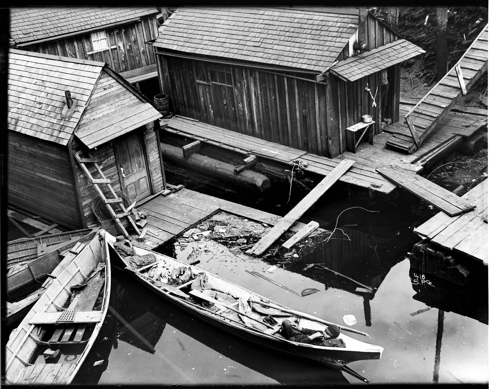 Image of Canoes at boathouse, Seattle, circa 1900