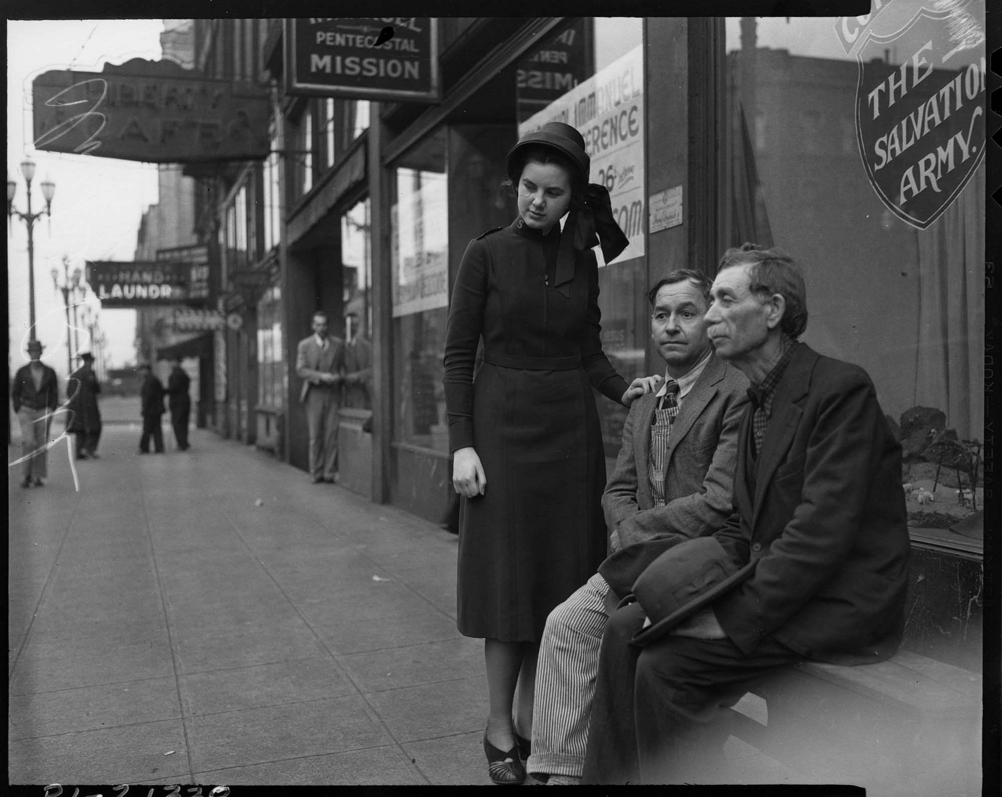 Image of Salvation Army worker with two men, May 1940