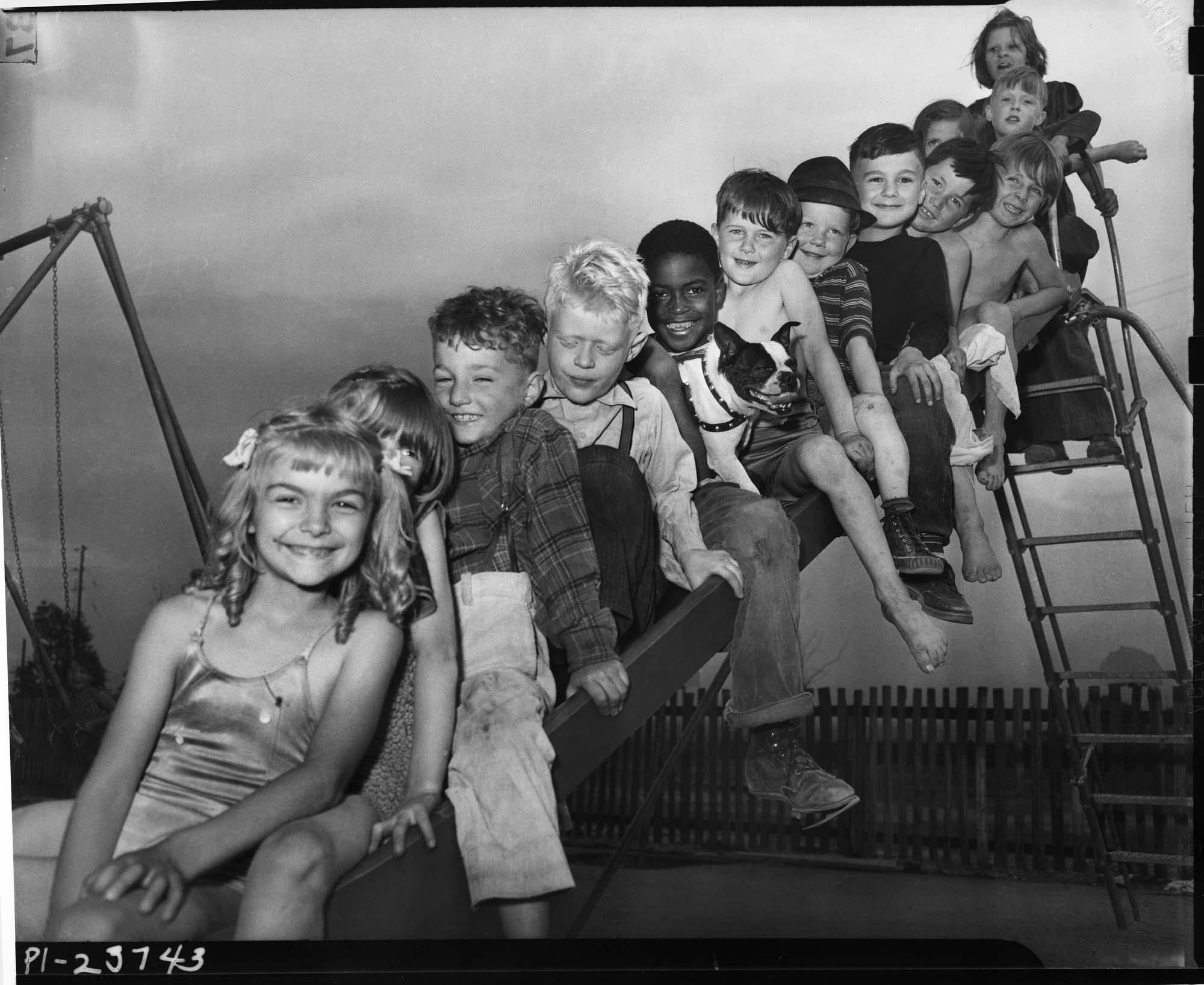 Image of Children on slide at Yesler Terrace playground, Seattle, 1942