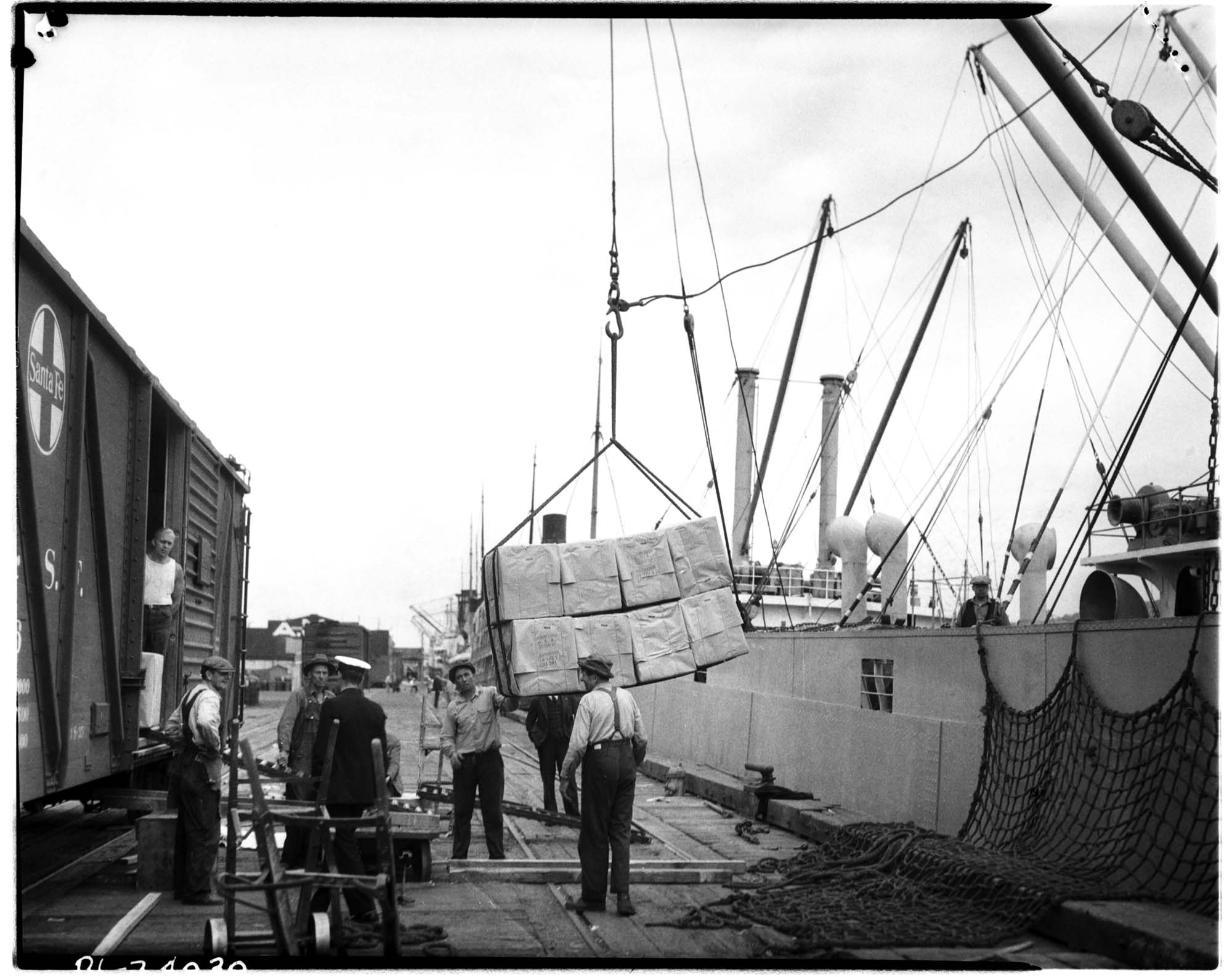 Image of Men unloading cargo from ship, circa 1935