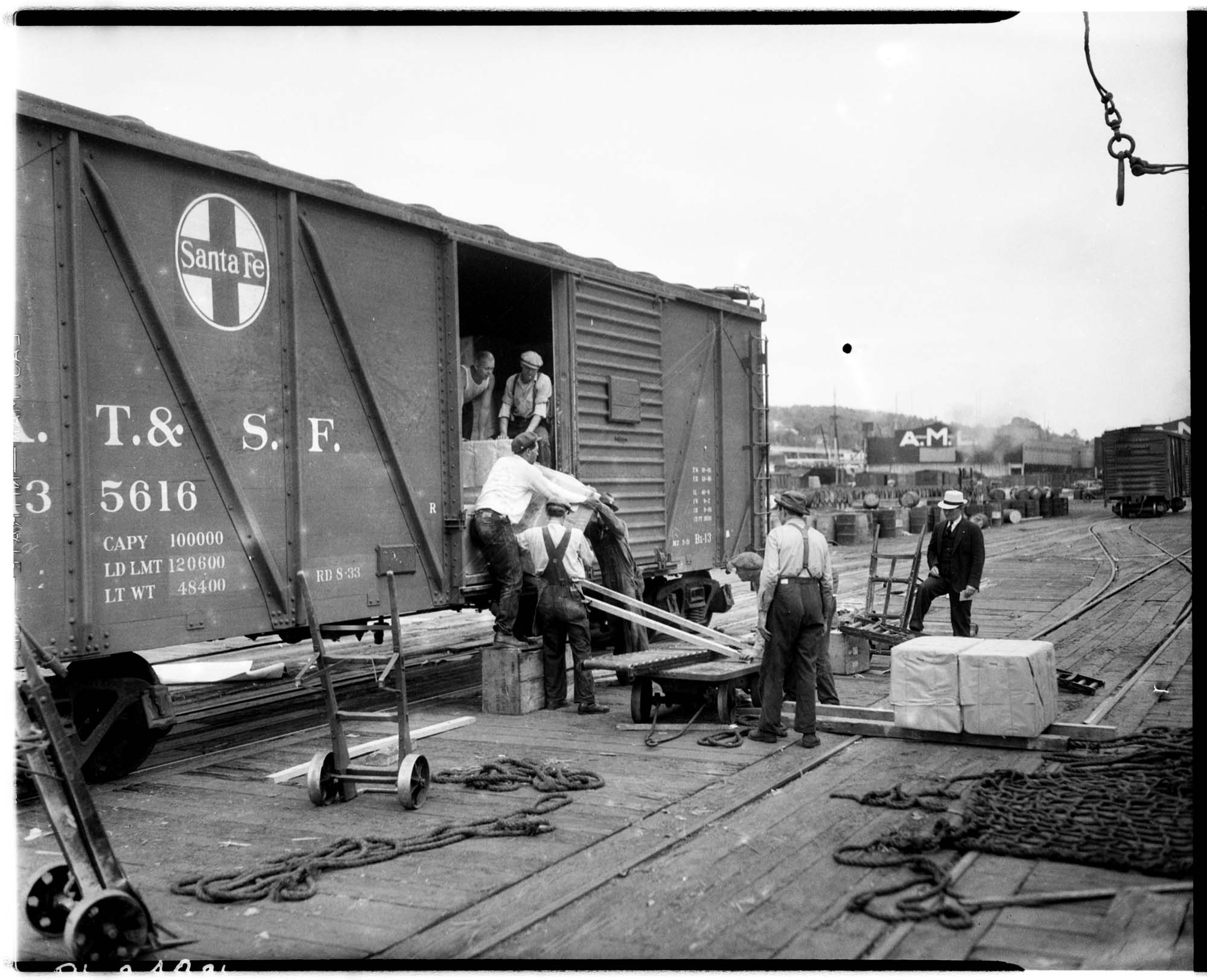 Image of Men loading boxcar at pier, circa 1935