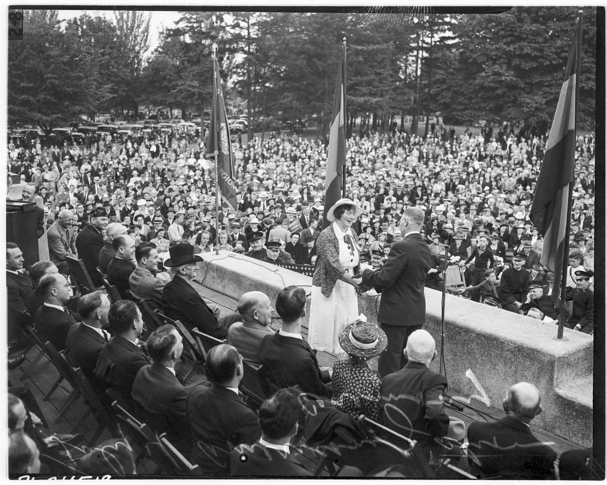 Image of Woman receiving citizenship at Woodland Park ceremony, Seattle, July 4, 1939