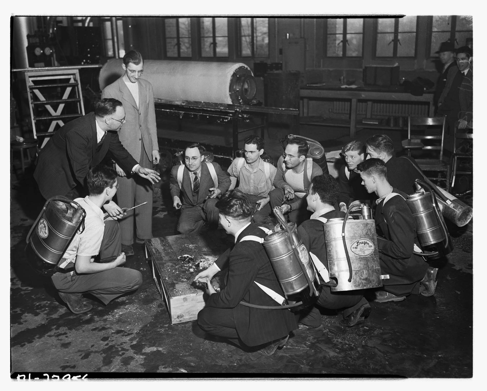 Image of University of Washington bomb squad with fire extinguishers, Seattle, 1942