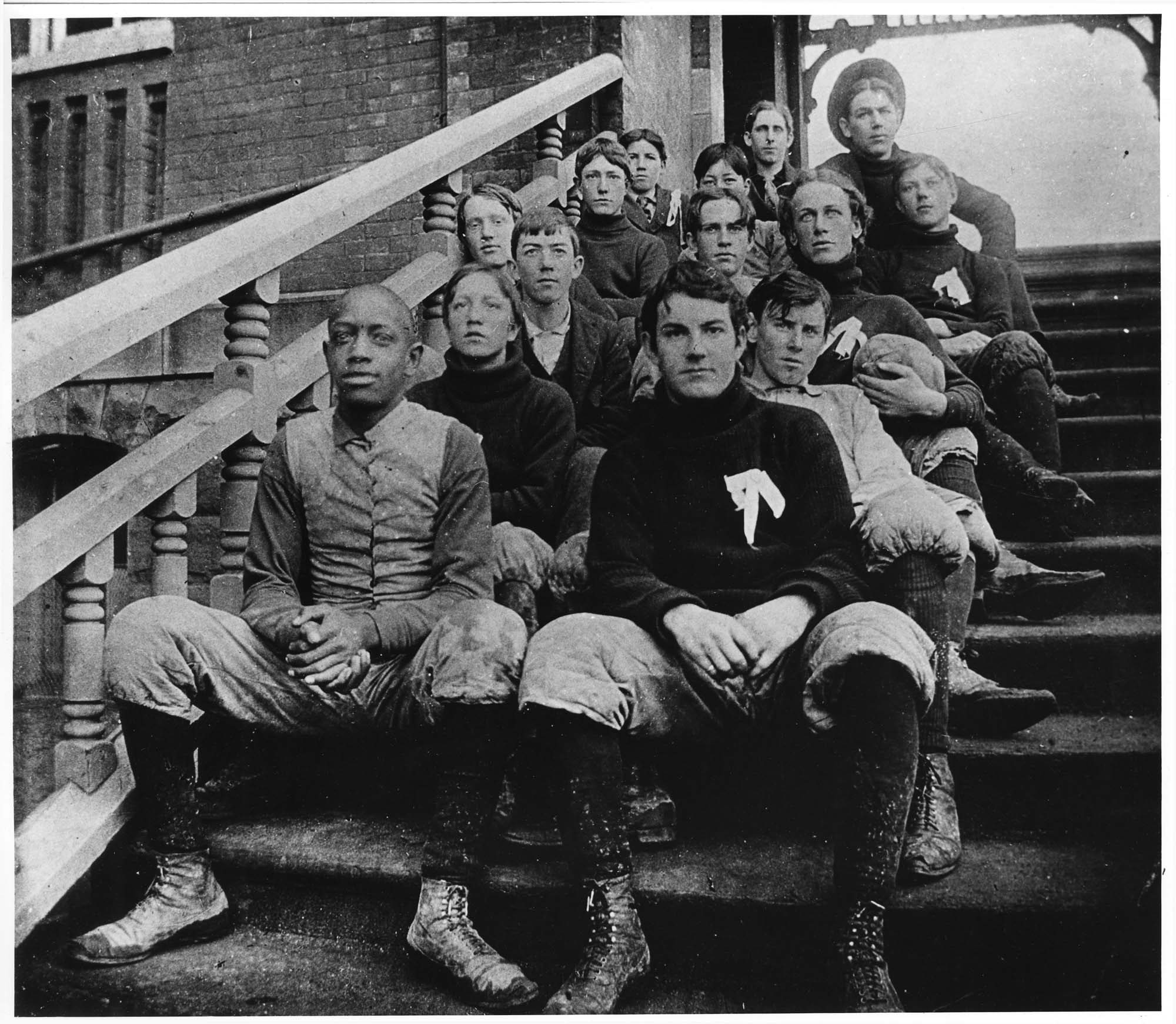 Image of Football team sitting on steps at South School, circa 1896