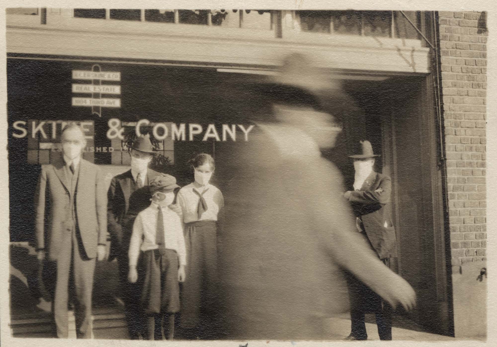 Image of Group wearing flu masks outside R.C. Erskine & Company, Seattle, 1918