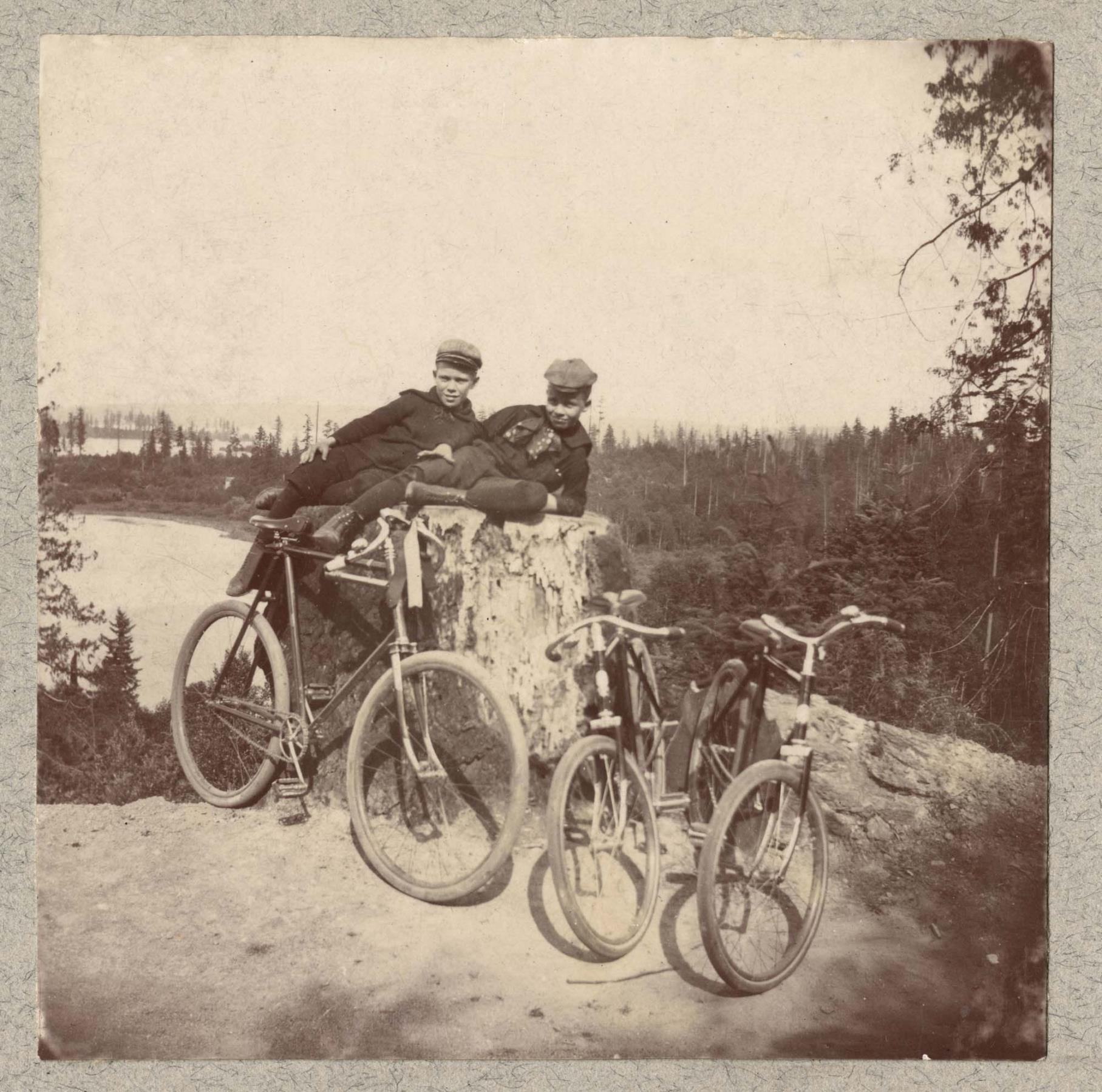 Image of Boys with bicycles above Portage Bay, Seattle, circa 1895