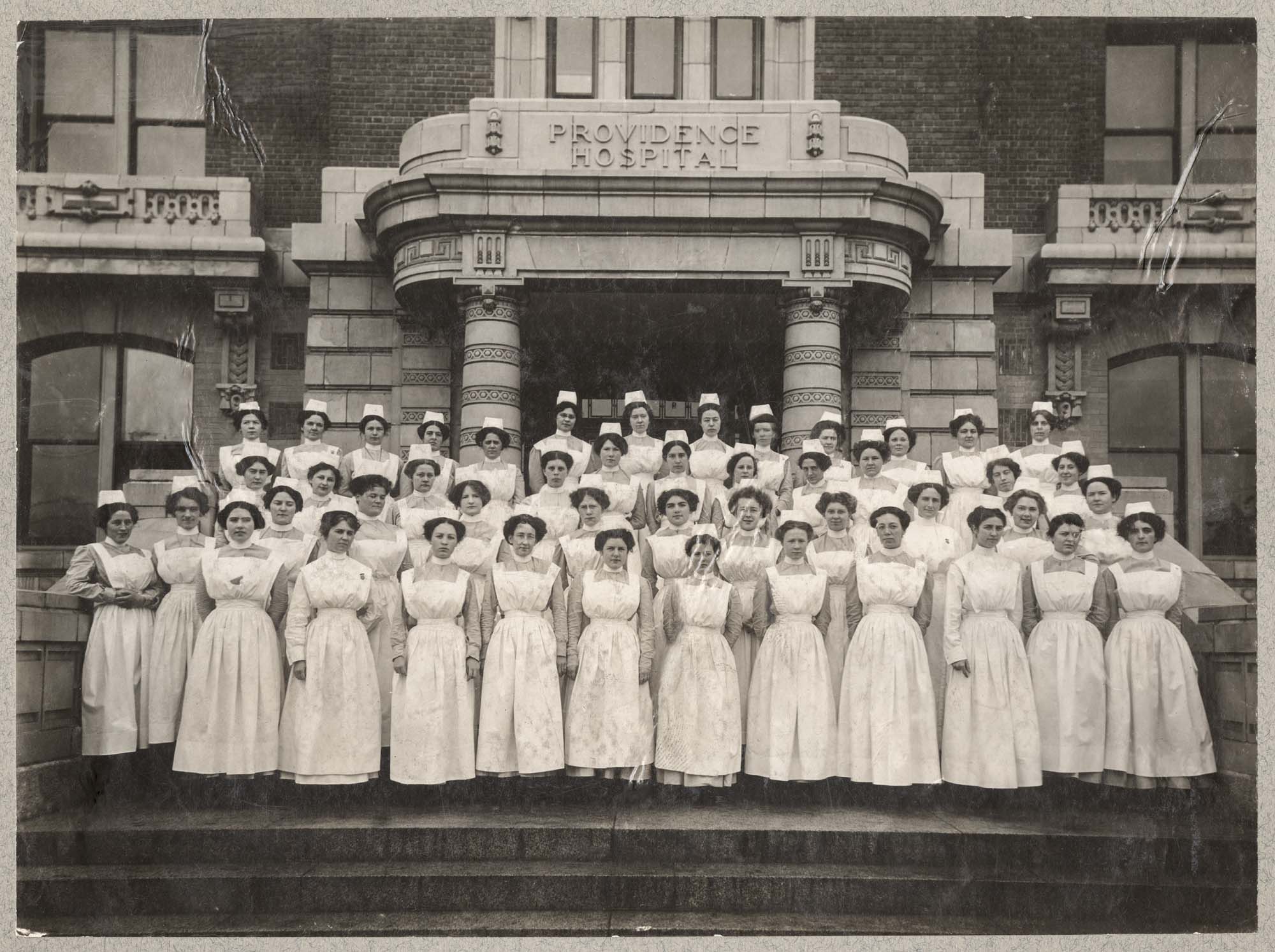 Image of Providence Hospital nurses standing on front steps, circa 1911