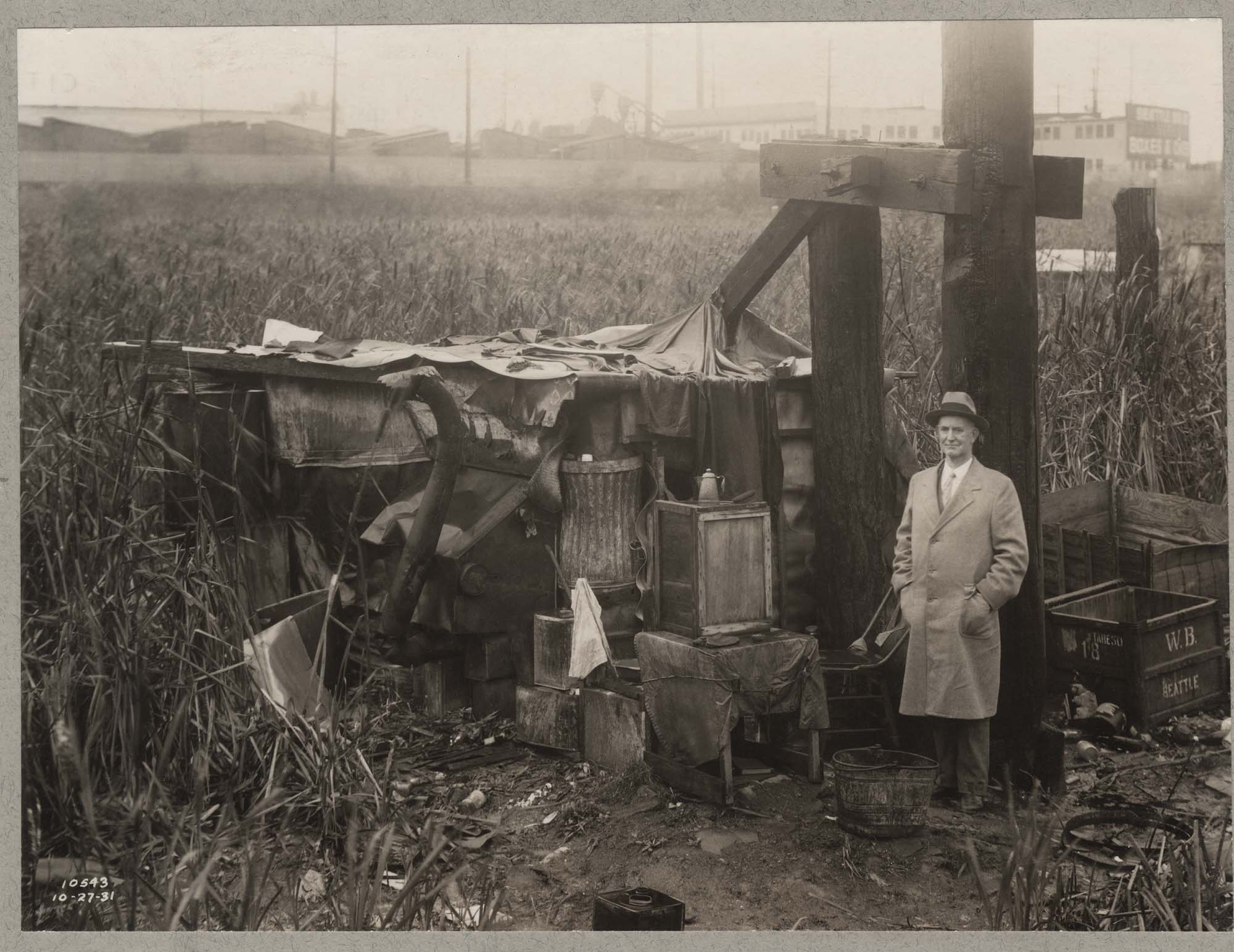 Image of Mayor Robert Harlan standing by a shack at Hooverville, October 27, 1931
