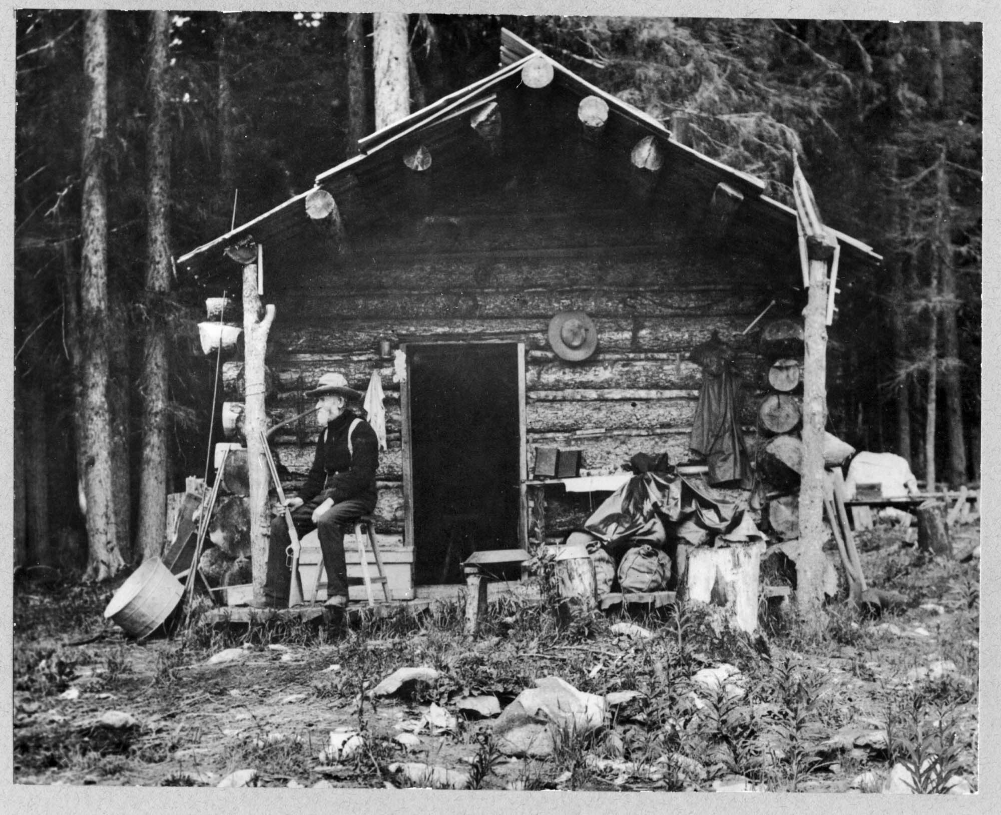 Image of David Denny at log cabin near Lake Keechelus, 1899