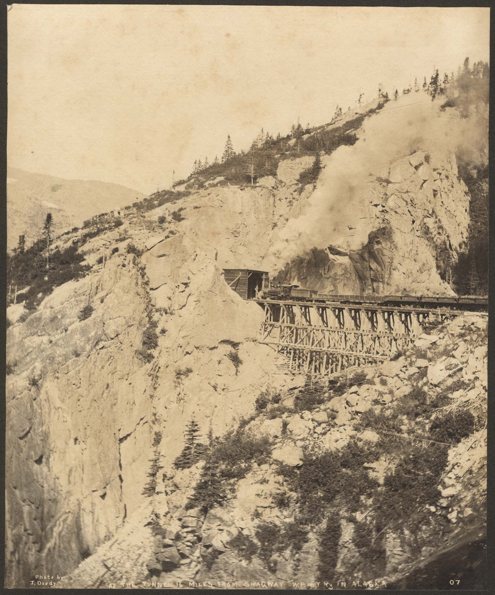 Image of White Pass & Yukon Route train, trestle, and tunnel, circa 1899
