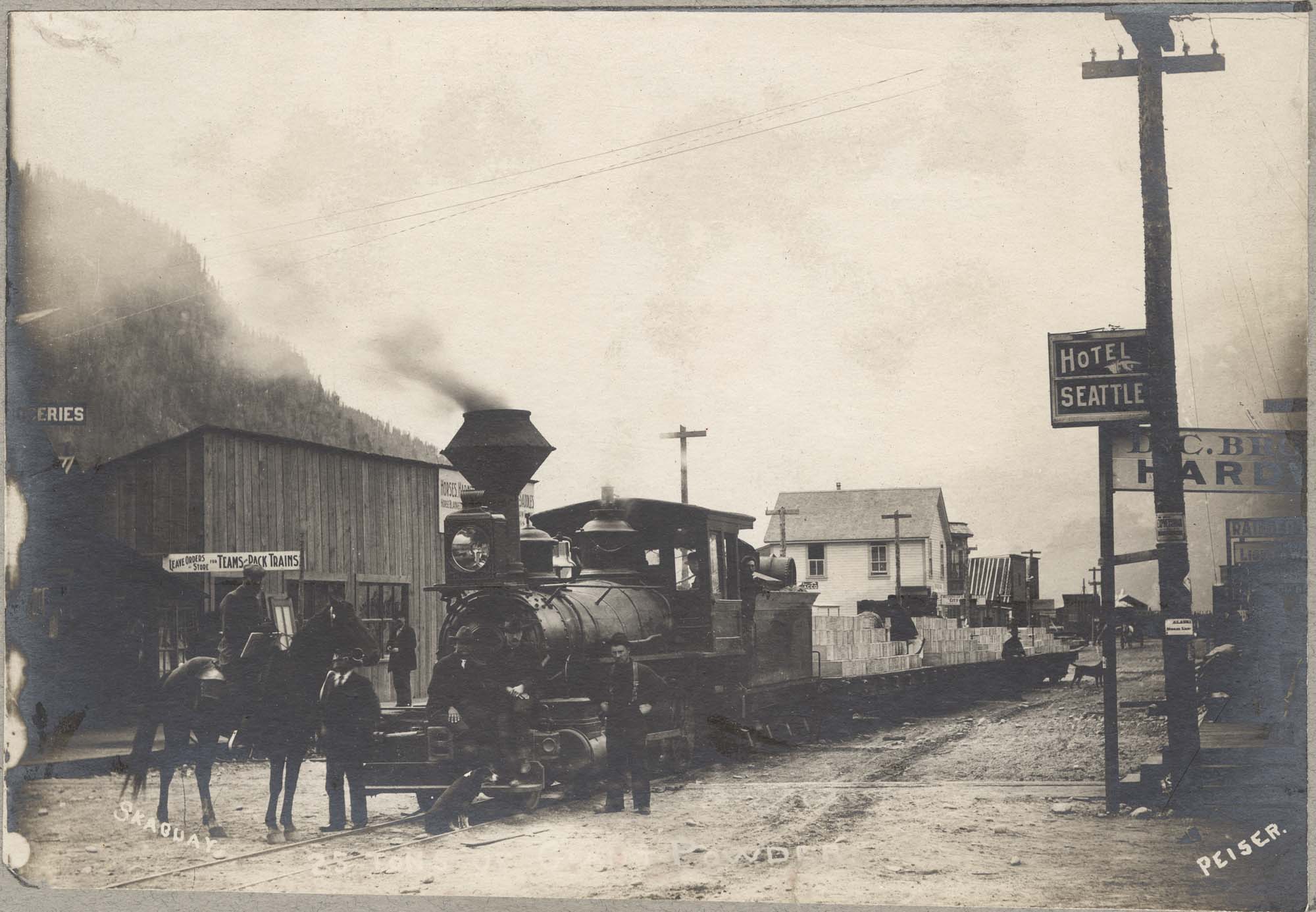 Image of Locomotive hauling powder through Skagway, circa 1902