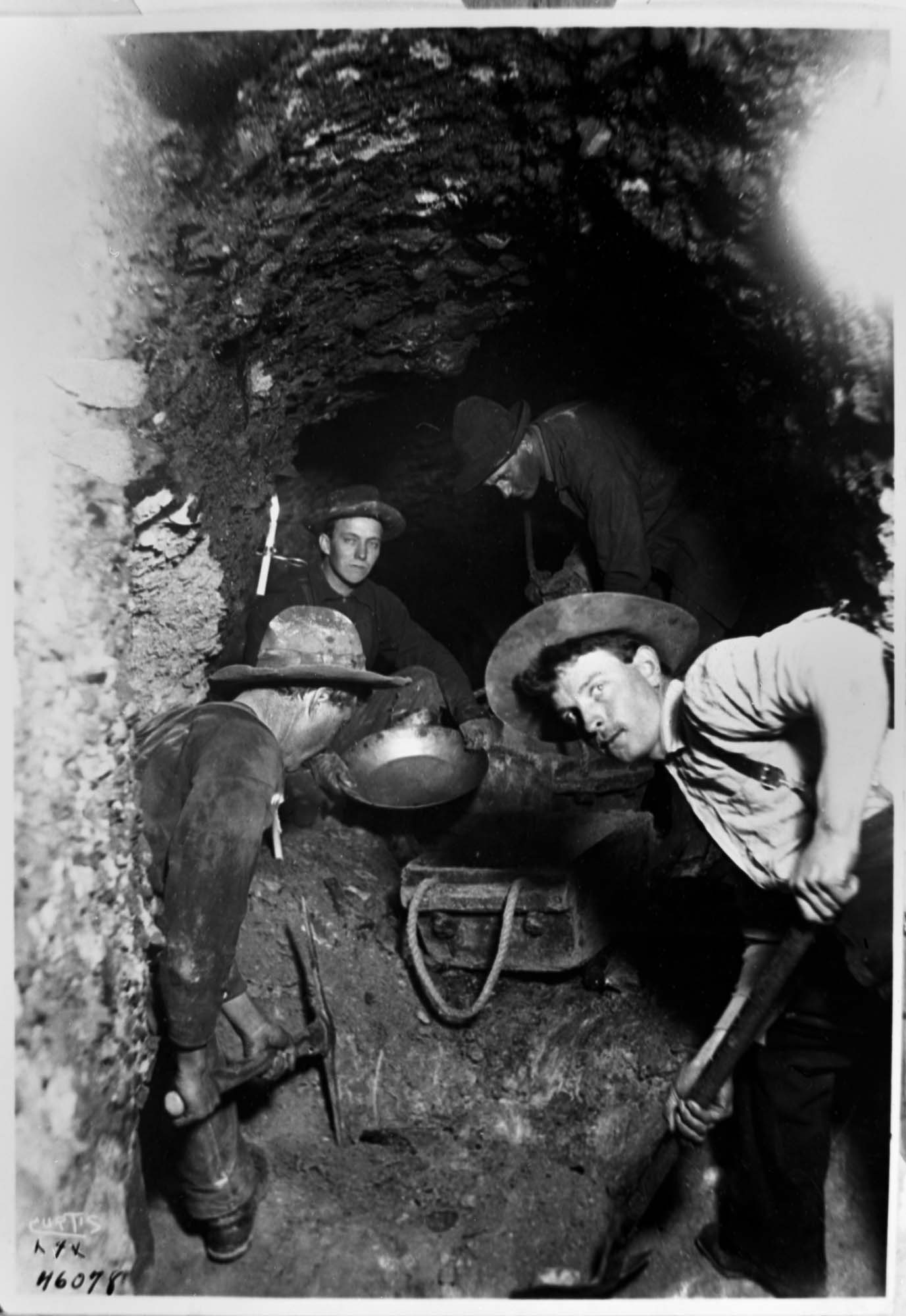 Image of Four men digging tunnel in gold mine at Eldorado, circa 1898