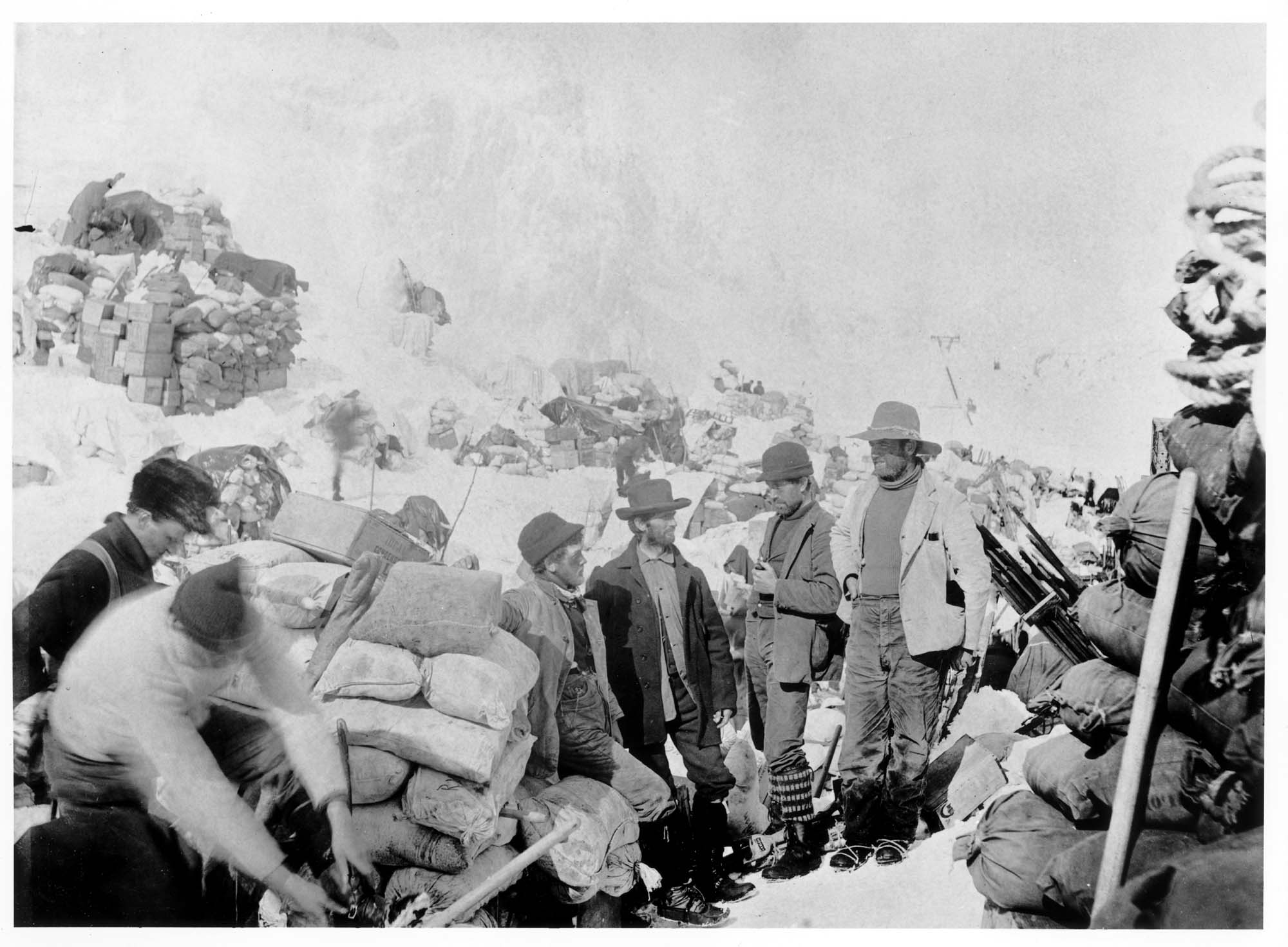 Image of Men with piles of supplies at Chilkoot Pass, circa 1898