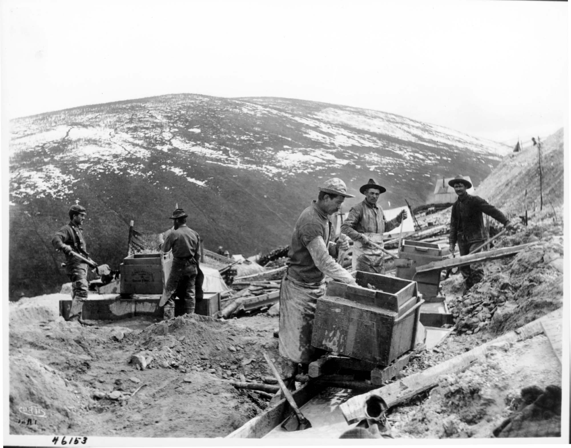 Image of Men using rockers to pan for gold, circa 1898