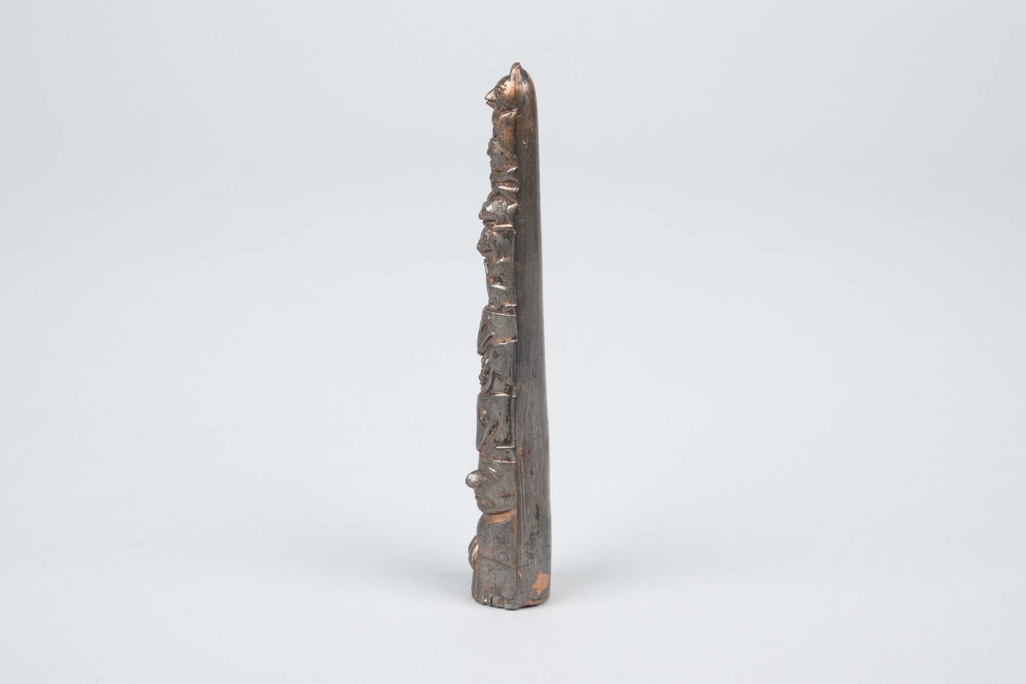 Image of Souvenir metal totem pole from the Golden Potlatch celebration, 1912