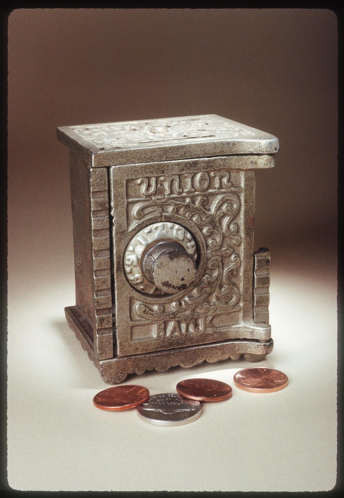 Image of Coin bank in the shape of a floor safe, ca. 1900