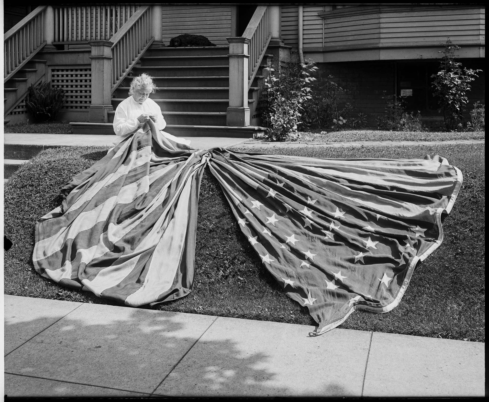 Image of Woman with large American flag, probably in Seattle, circa 1917