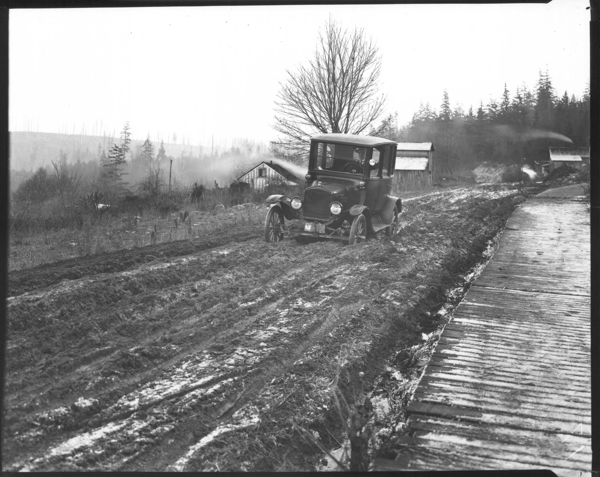 Image of Car stuck on muddy road, circa 1927