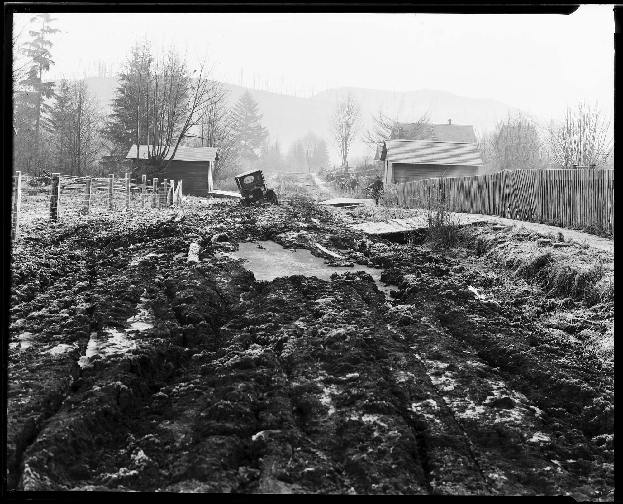 Image of Car stuck on a muddy road, circa 1924