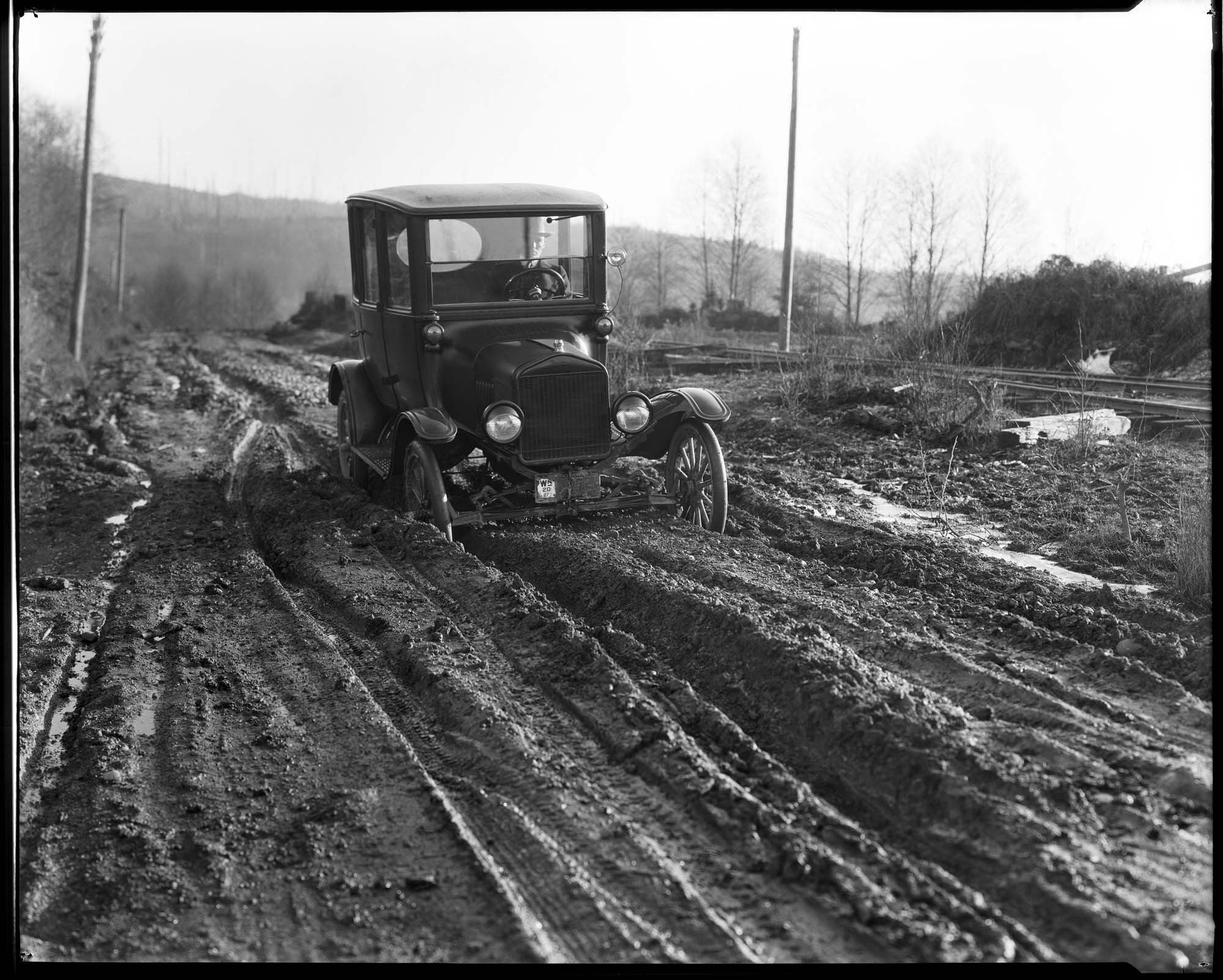 Image of Car stuck on muddy road, circa 1927