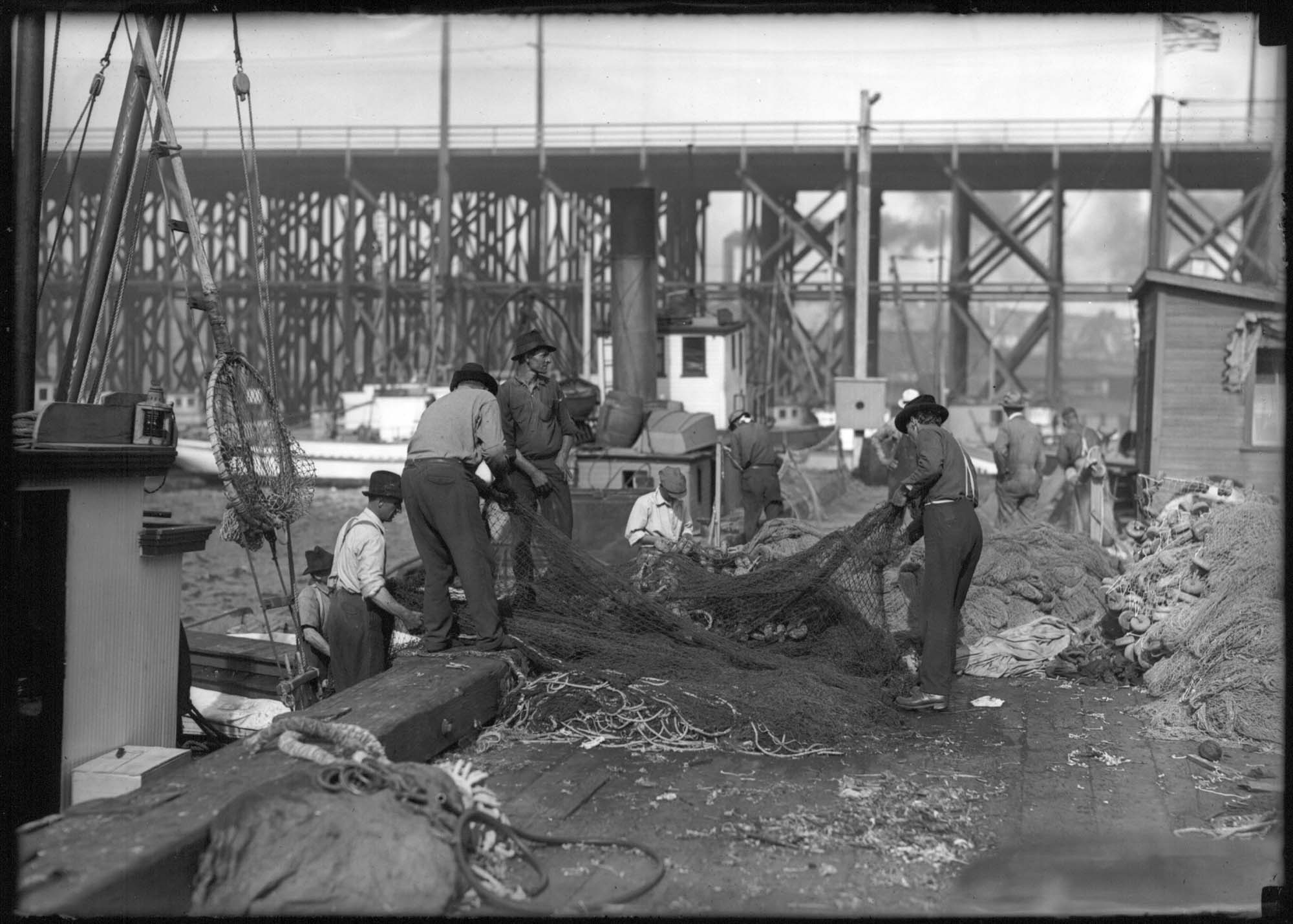 Image of Fishermen checking nets at  Fisherman's Terminal, Seattle, circa 1918