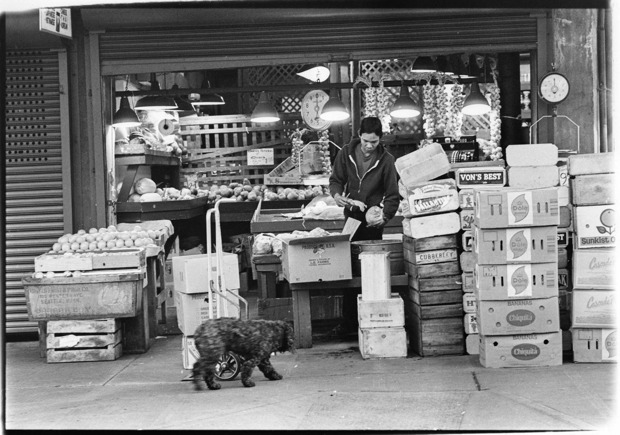 Image of Vendor with boxes of produce at Pike Place Market, Seattle, September 23, 1983