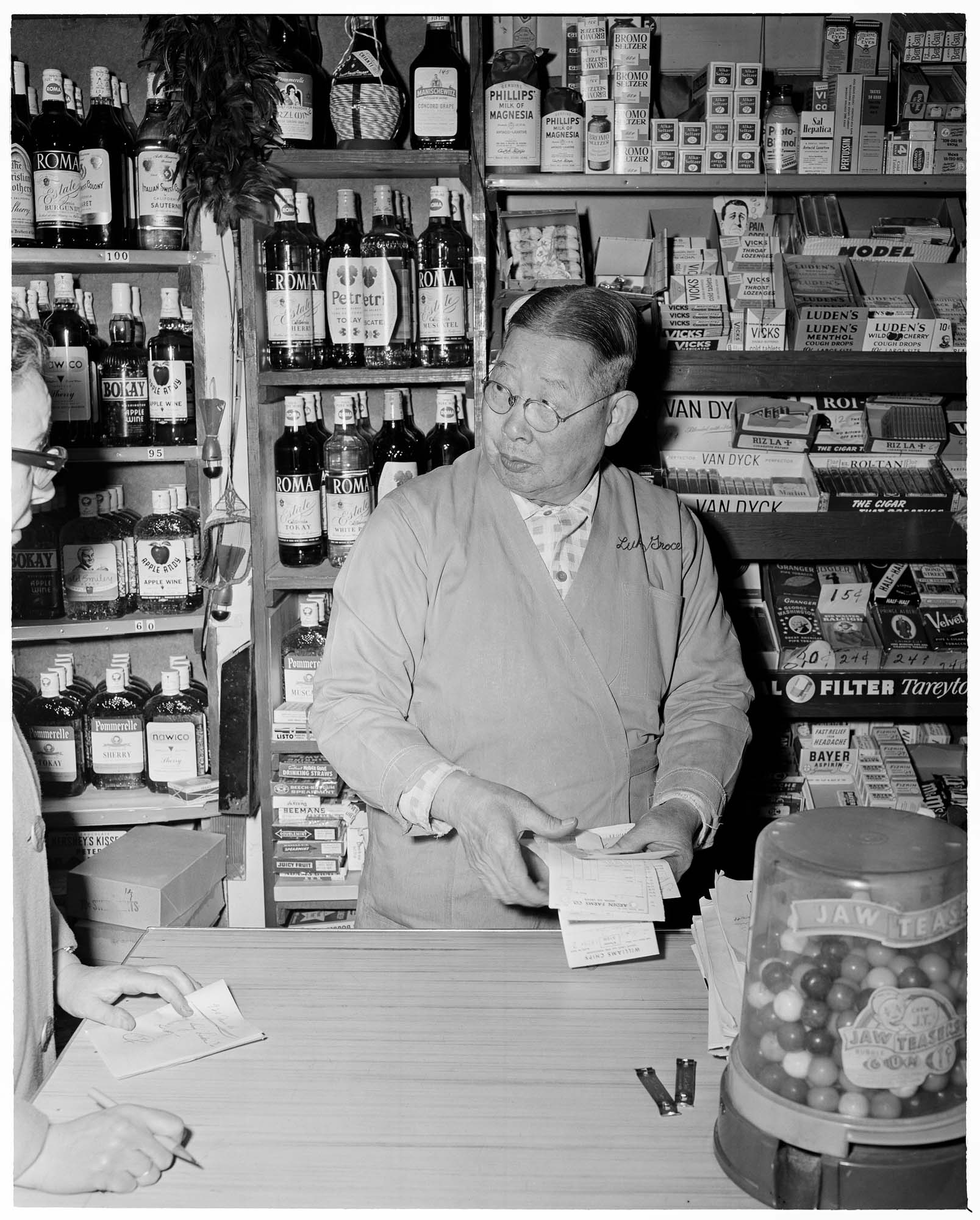 Image of Lung Sing Luke in his grocery store at 920 James Street, Seattle, February 26, 1960