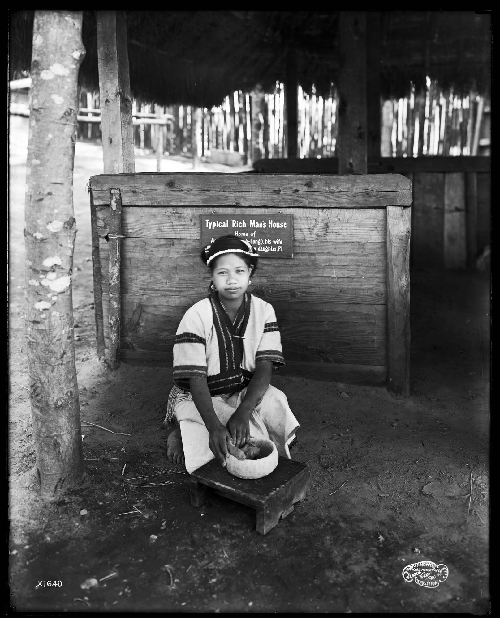 Image of Young woman making clay pot in Igorrote Village, Alaska-Yukon-Pacific Exposition, Seattle, 1909
