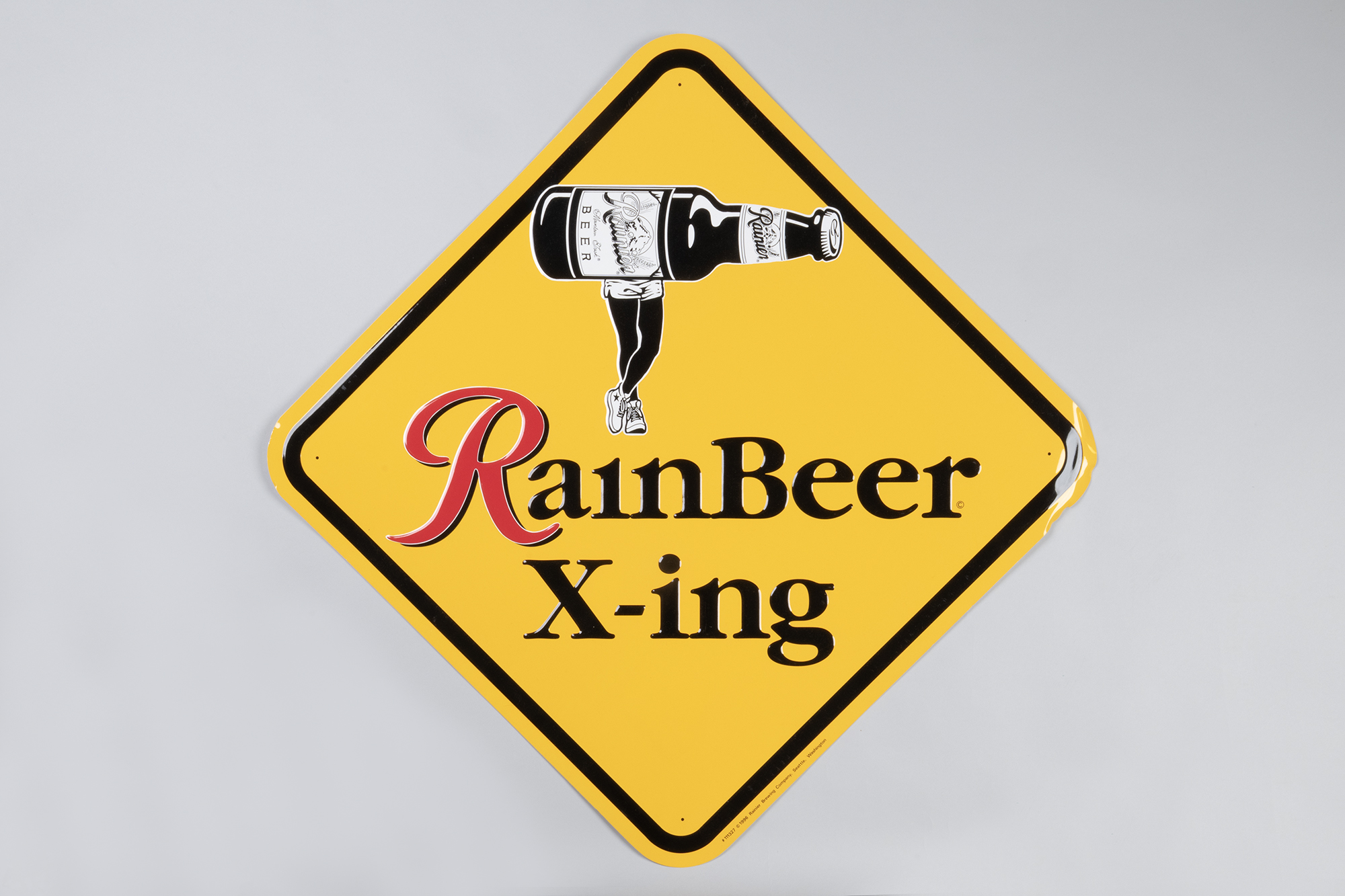 Image of Mock road crossing sign advertising Rainier Beer, ca. 1996
