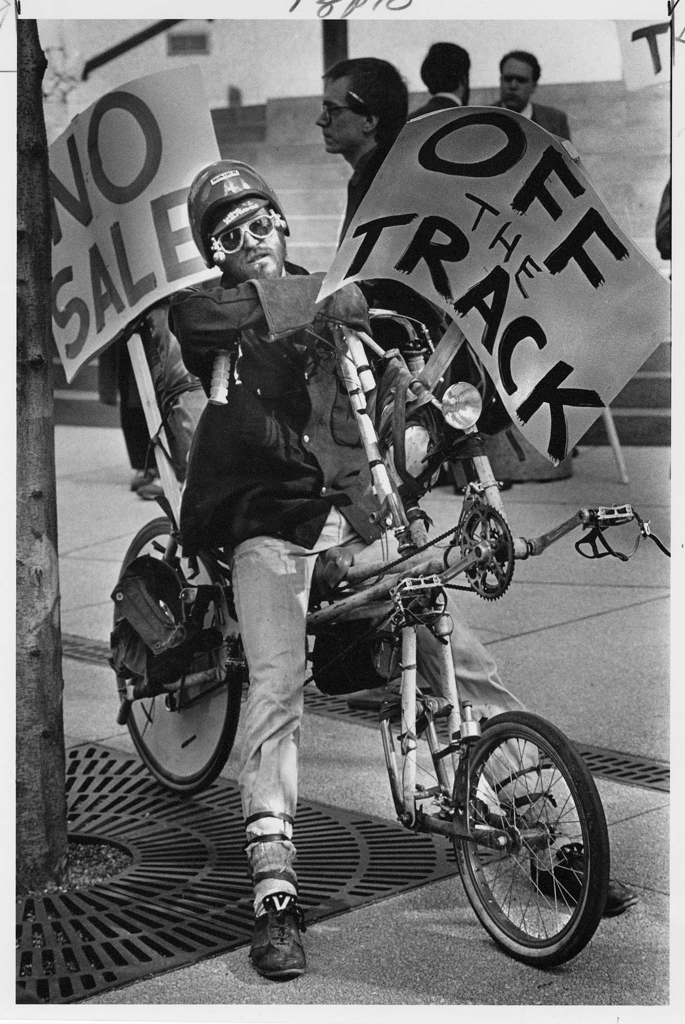 Image of Joe Kochanowski on his homemade bike at protest concerning the Burke-Gilman trail extension, Seattle, March 3, 1988