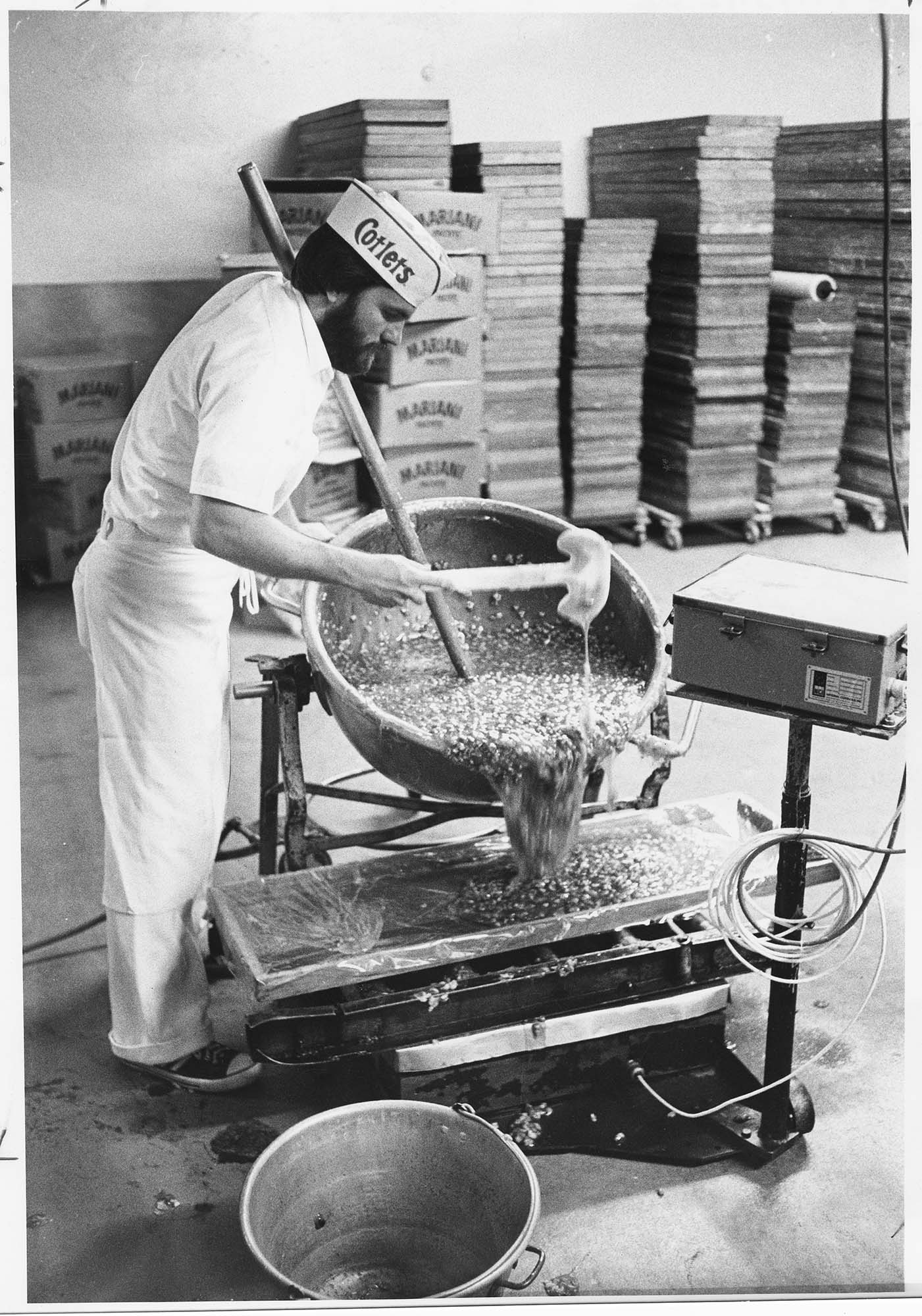 Image of Liberty Orchards employee David Firth pouring candy into cooling tray, Cashmere, WA, August 1978