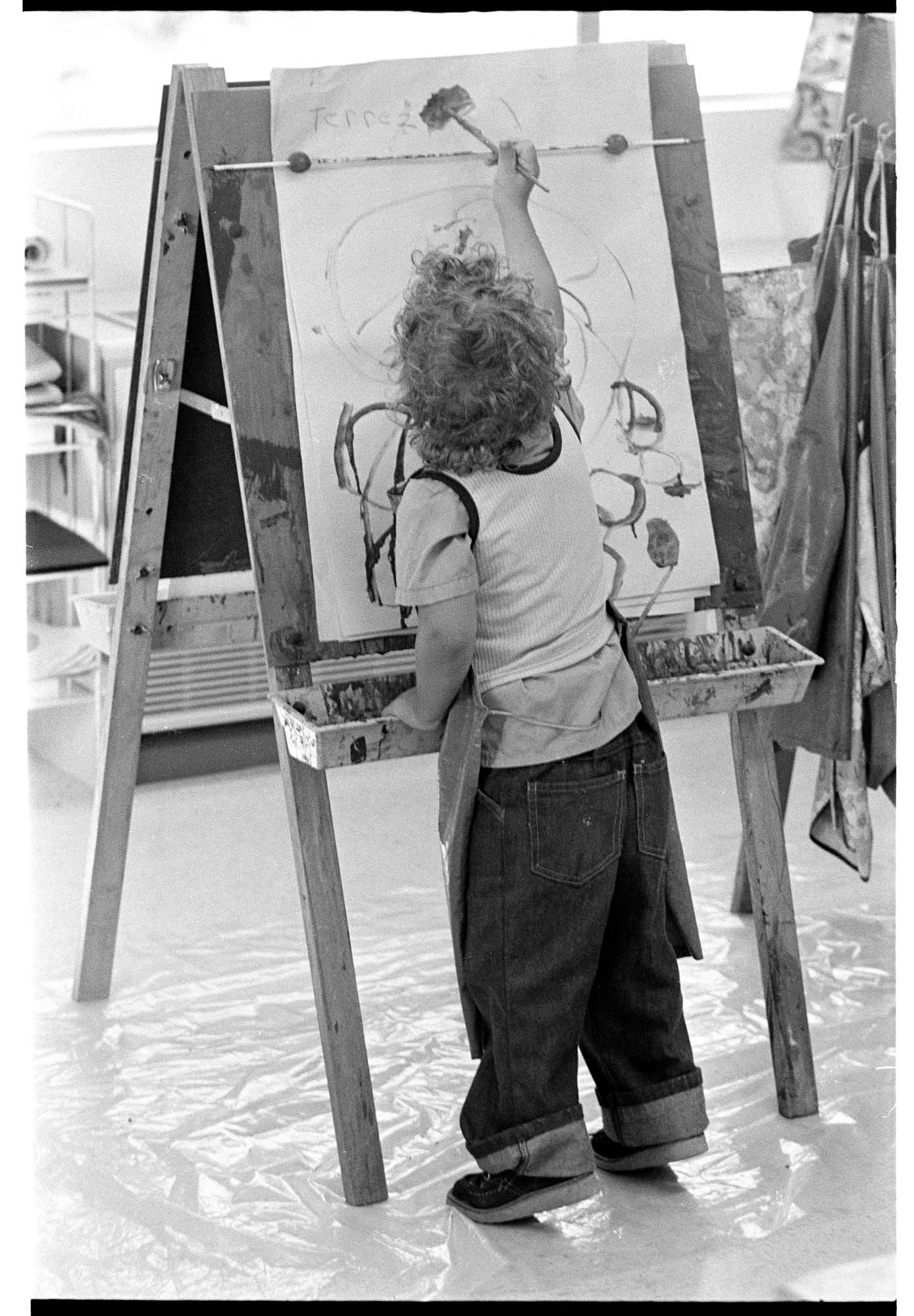 Image of Terrez Weir painting at El Centro de la Raza's bilingual child care program, Seattle, September 1974