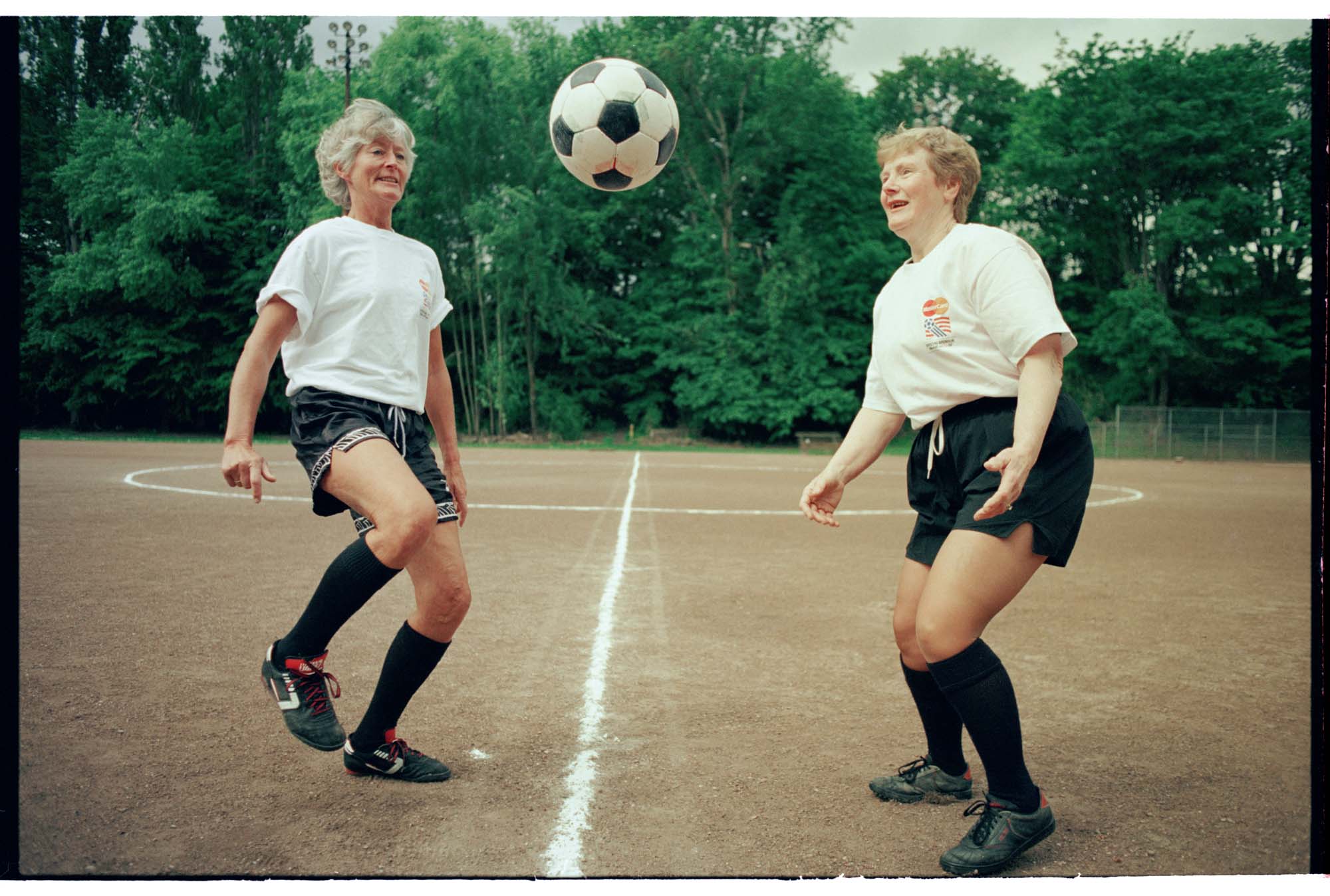 Image of Maj Surowiecki and Bernadette Noonan kicking a soccer ball, May 1994