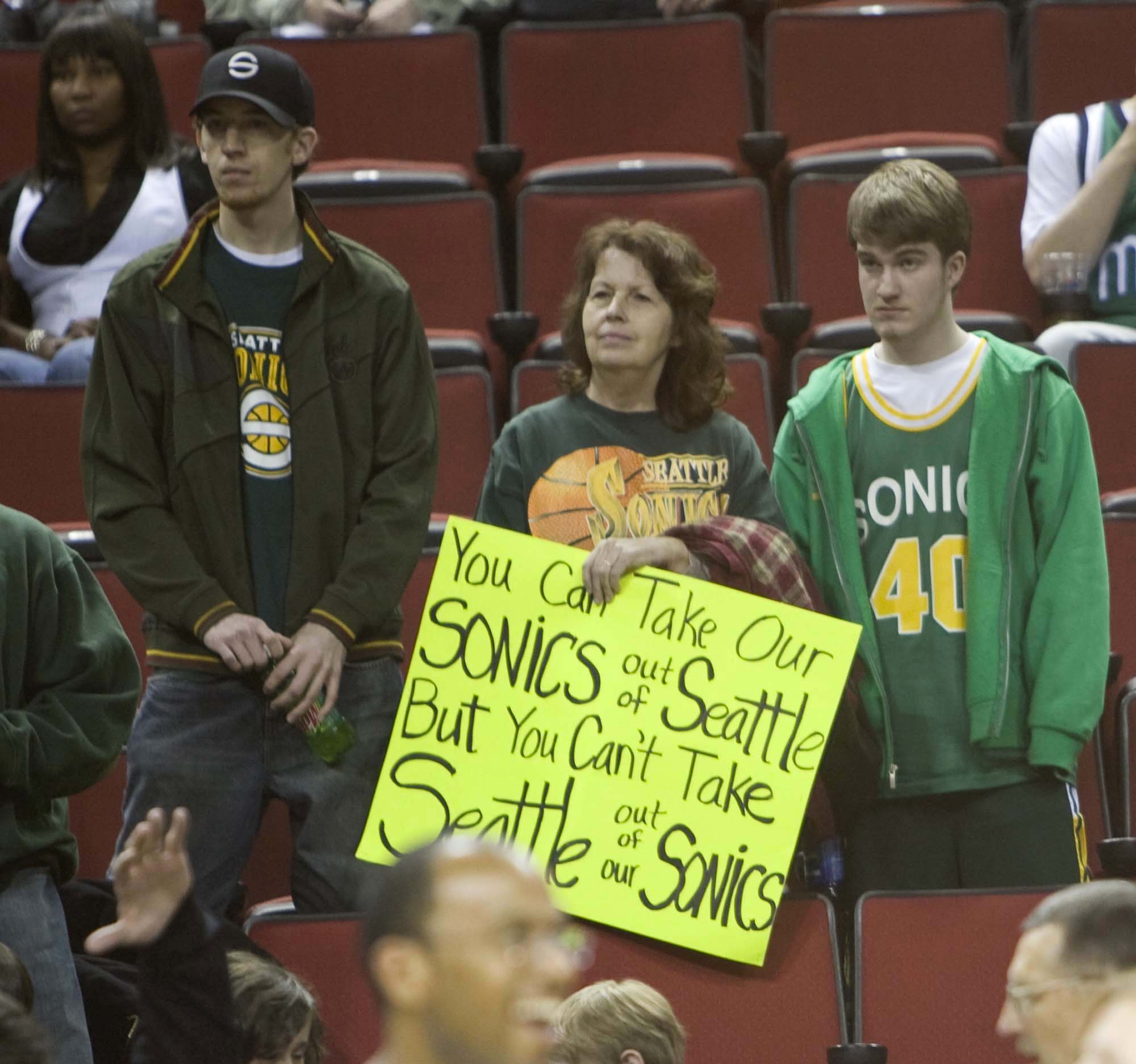 Image of Fans with sign at last Sonics home game before move to Oklahoma, April 13, 2008