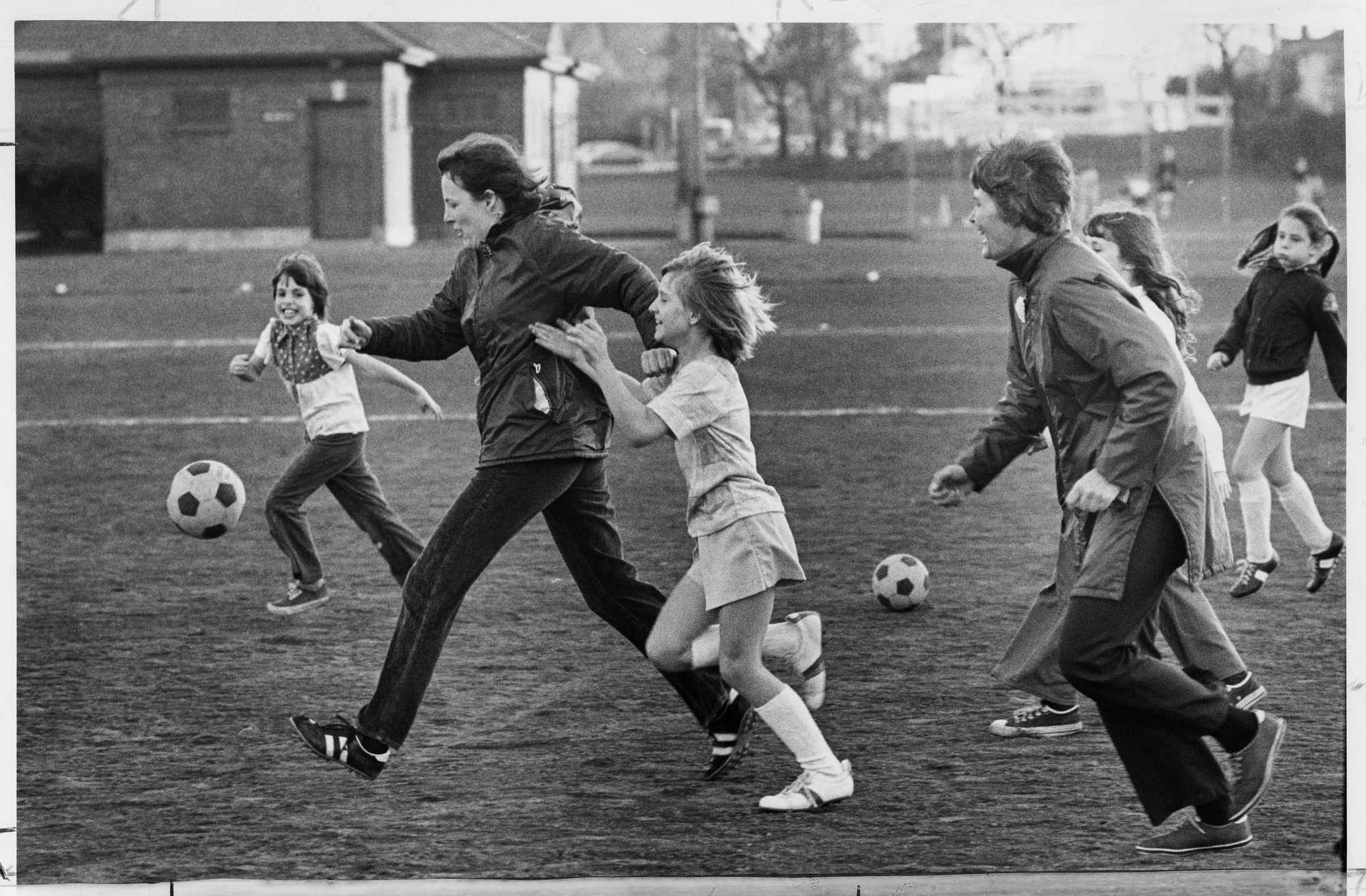 Image of Woodland Sizzlers girls soccer team practice with coaches, Seattle, November 20, 1976
