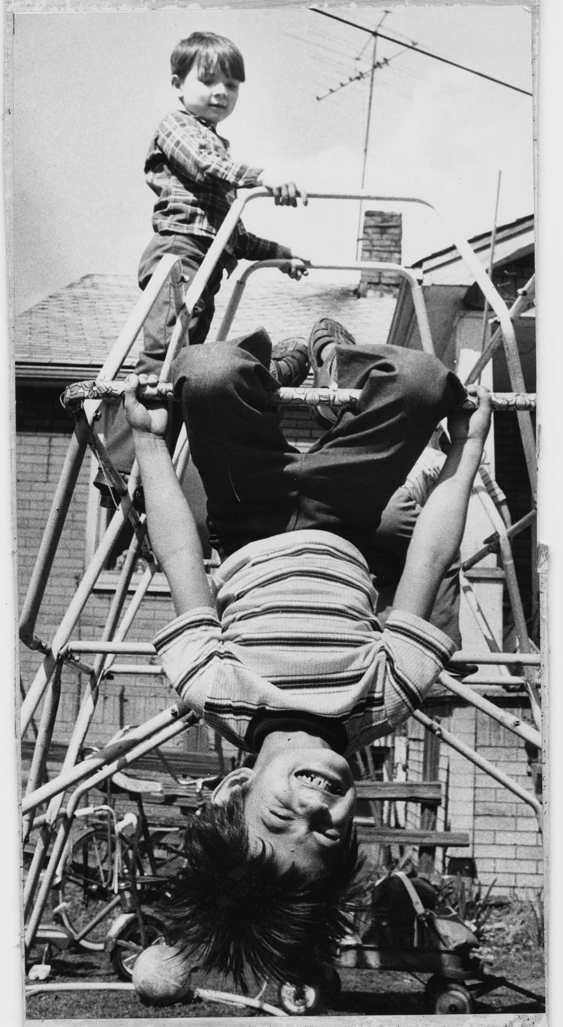 Image of Lê Quốc Thân playing outside with his foster brother, Renton, April 8, 1975