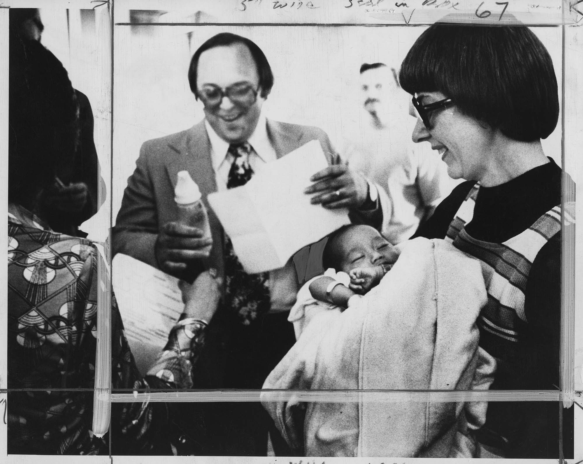 Image of Foster parents John and Lana Mitsules with baby Thi Dung Hanh at SeaTac Airport, SeaTac, April 6, 1975
