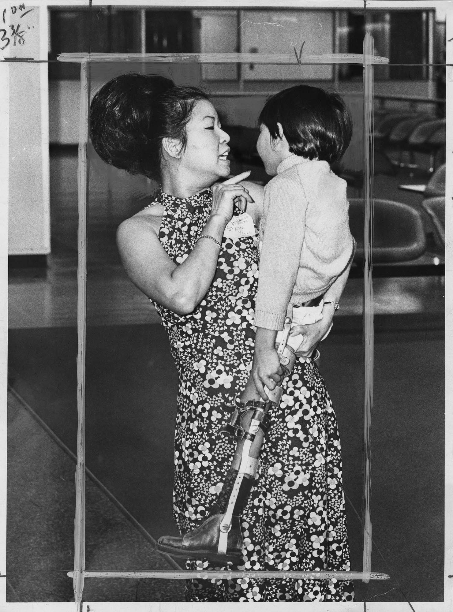 Image of Loan Young of Alderwood Manor with Vietnamese child, Sea-Tac, April 6, 1975
