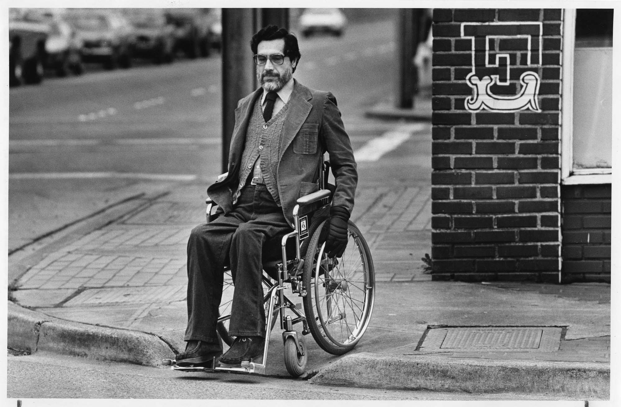Image of Martin J. Weideman using a curb ramp, Seattle, February 1981