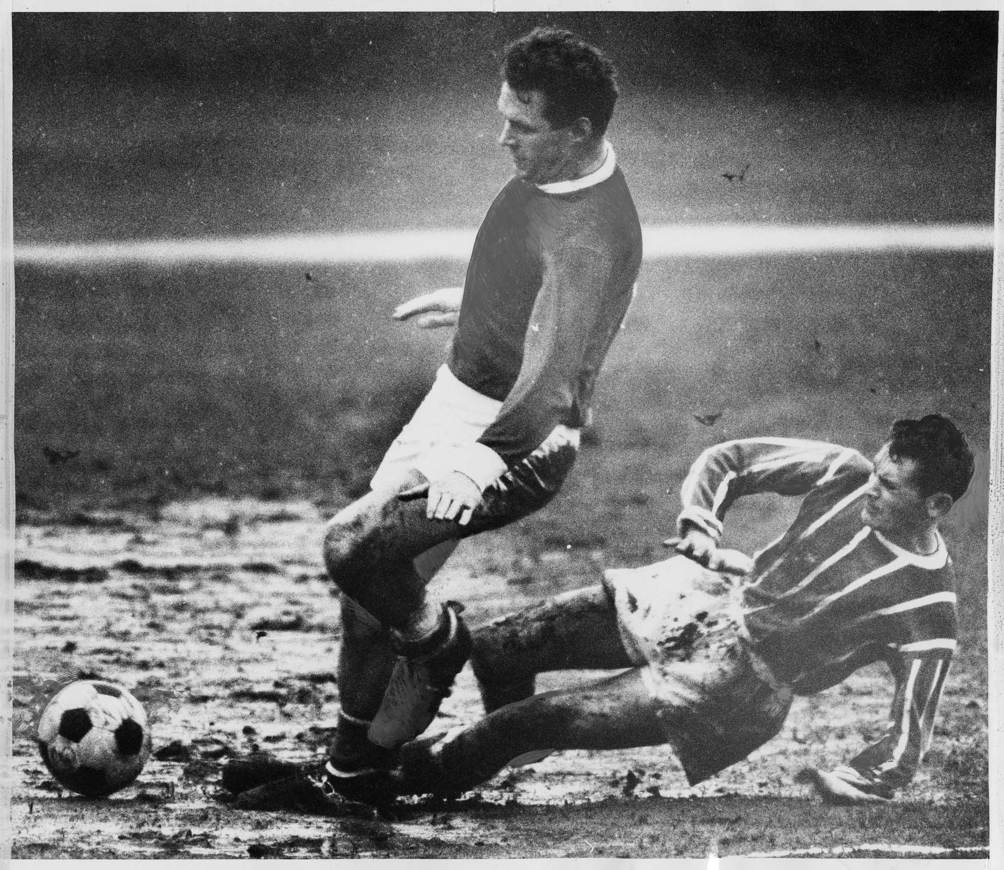 Image of Seattle Hungarians'  Brian Franklin with Boeing Employees opponent in the rain on a West Seattle field, December 15, 1968