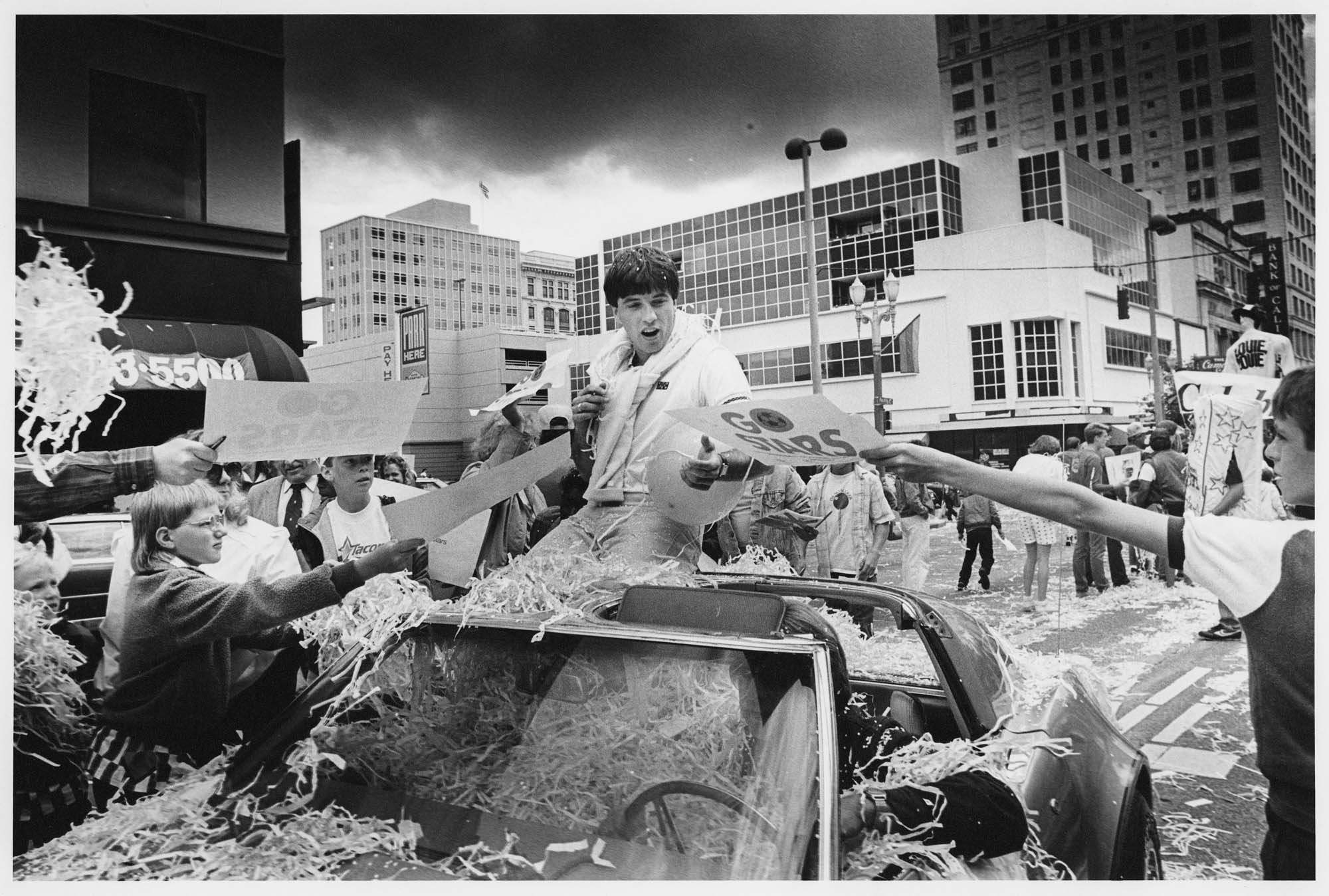Image of Tacoma Stars player Preki surrounded by fans during a parade to honor the team, Seattle June 22, 1987